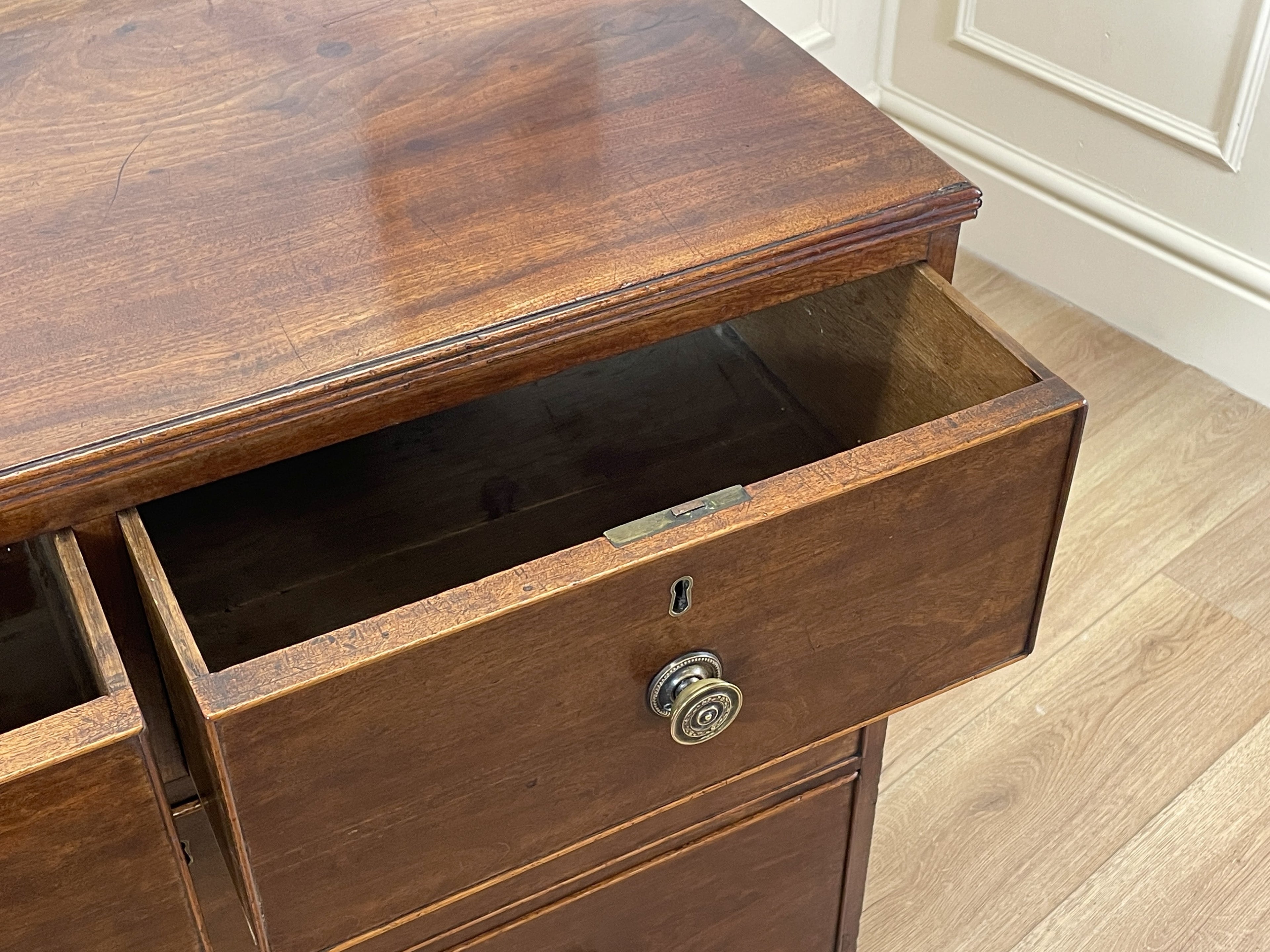 Wooden drawer with a knob on a wooden cabinet.