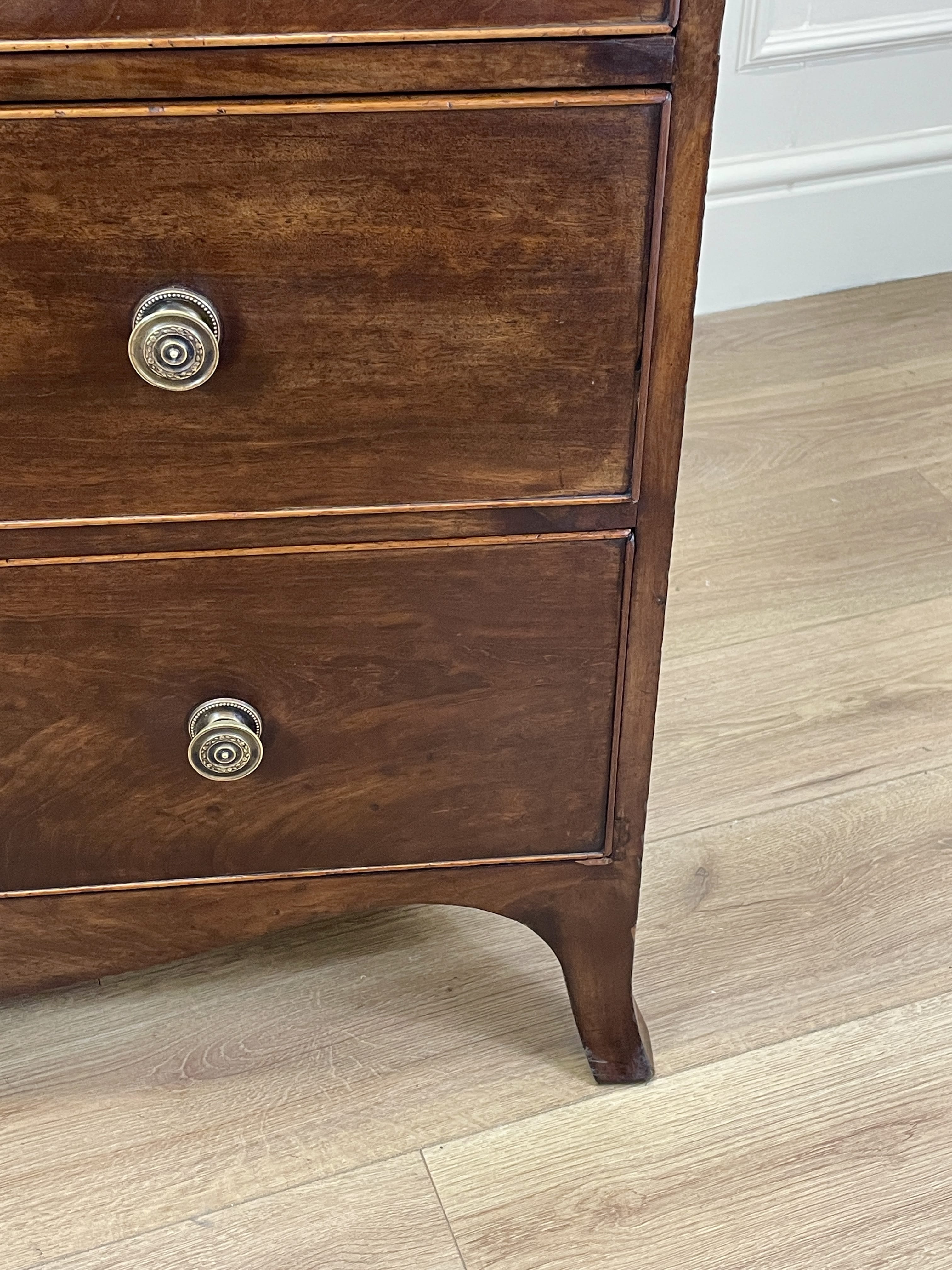 Wooden dresser with two drawers on a wooden floor.