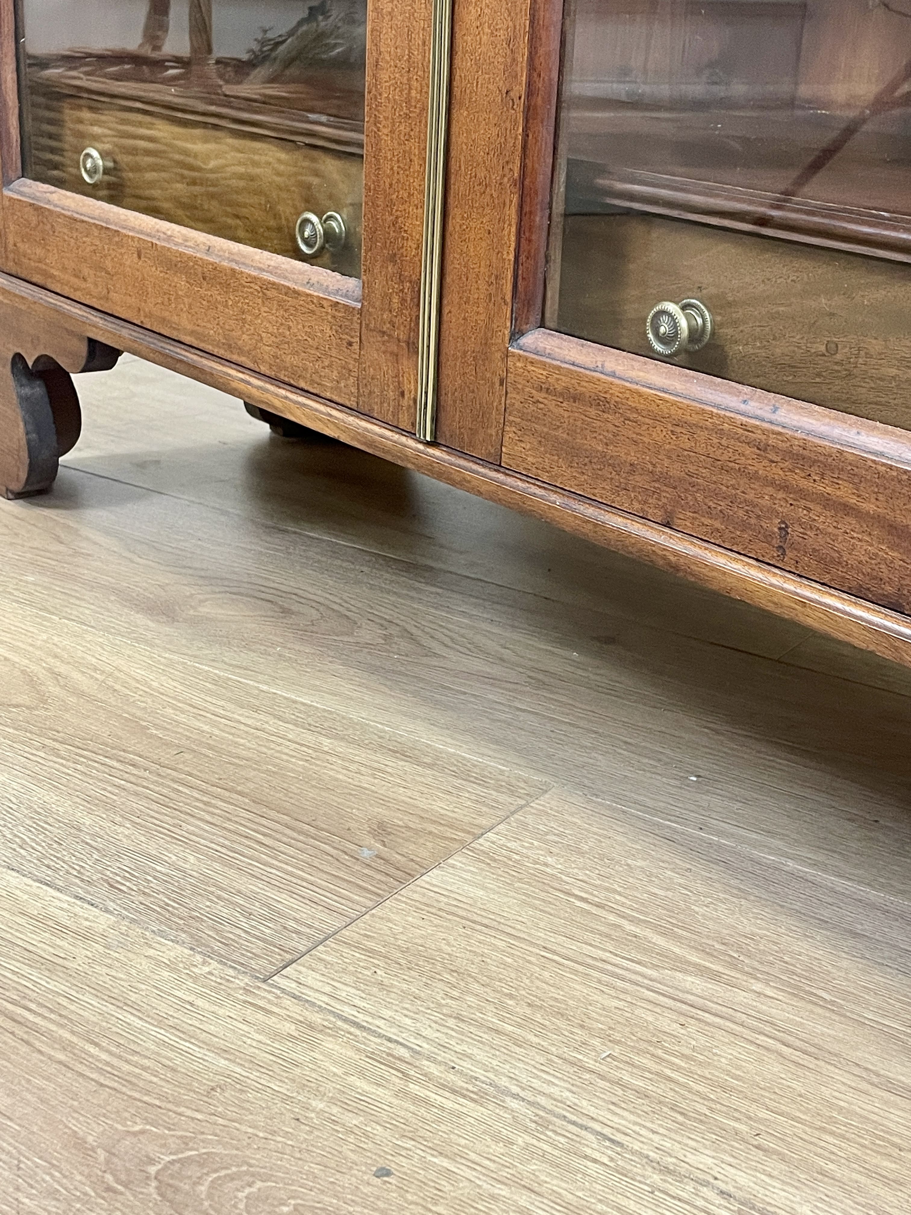 Wooden cabinet with glass doors on a wooden floor