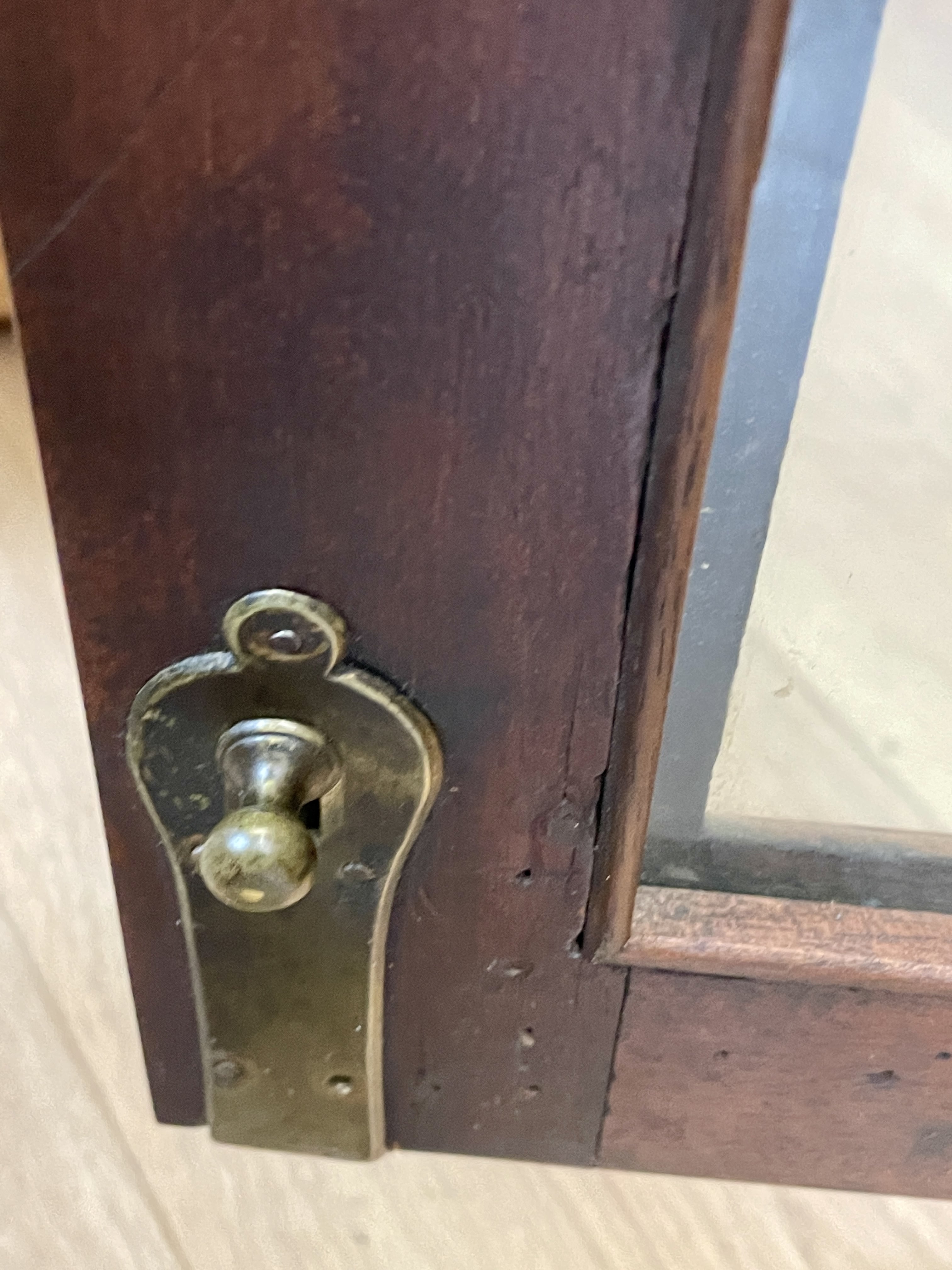 Wooden door with a brass doorknob and lock mechanism.