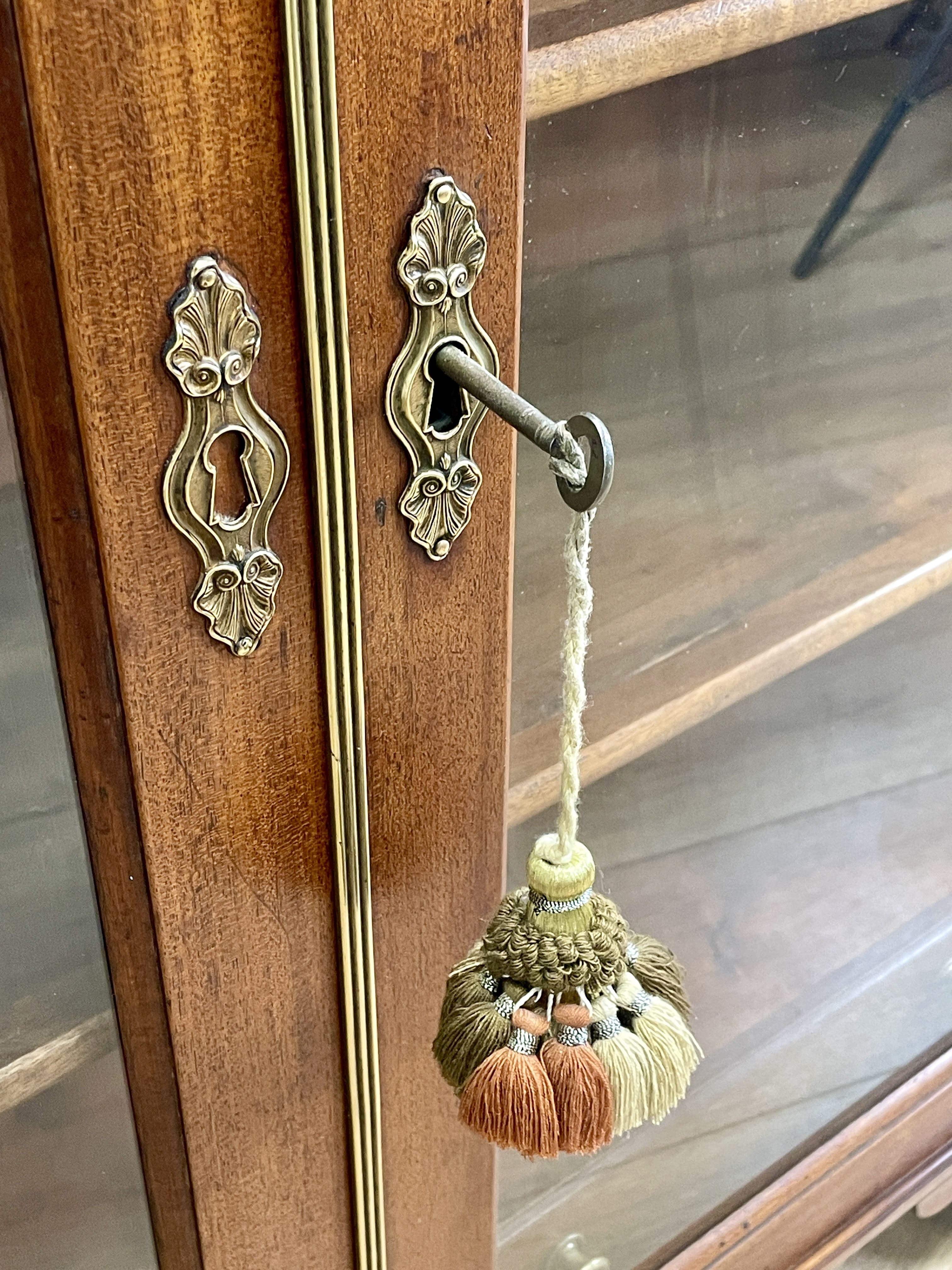 Decorative door handle with tassels on a wooden door
