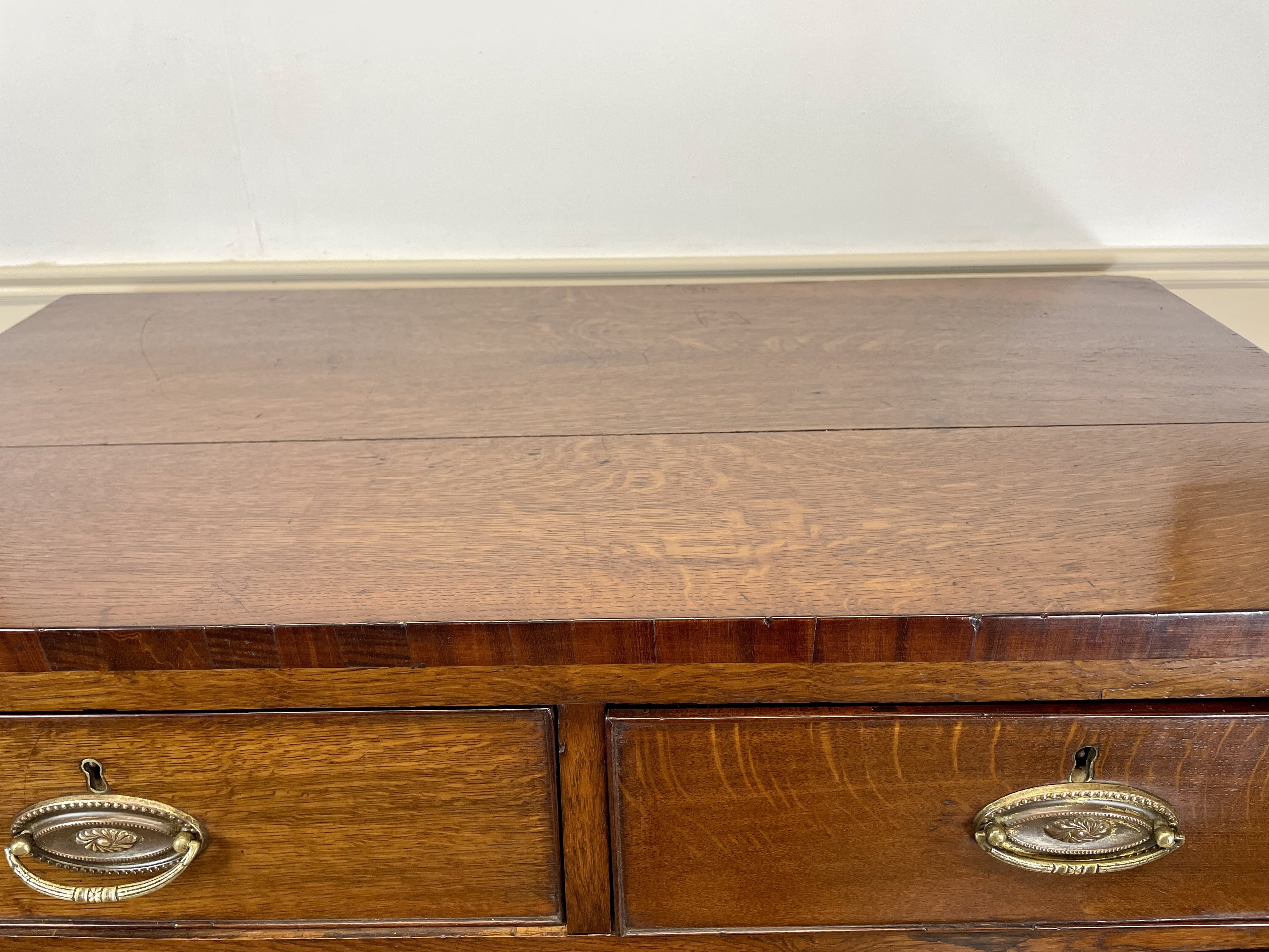 Wooden desk with two drawers and brass handles on a white background