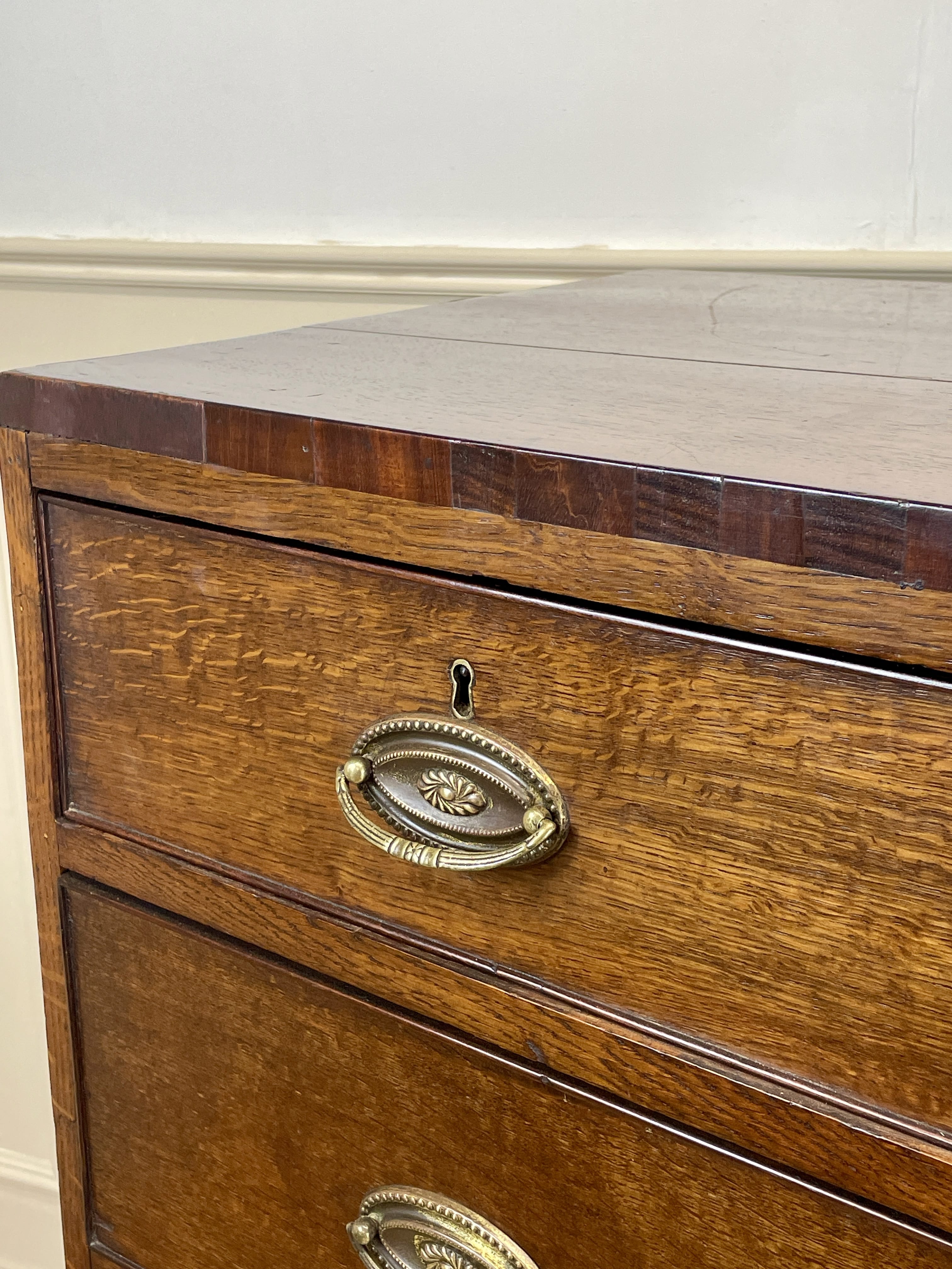 Wooden drawer with brass handle on a white background