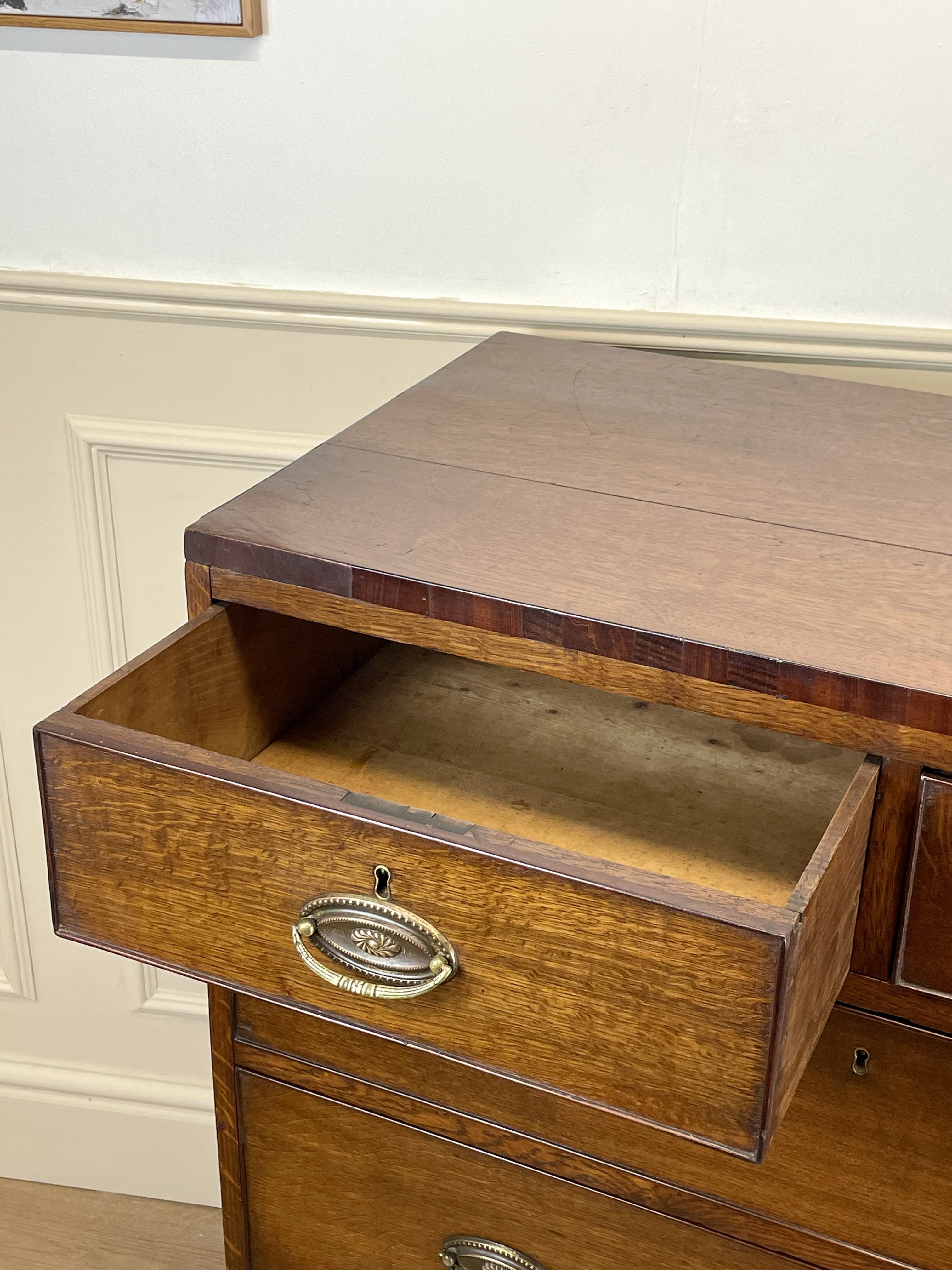 Wooden desk with an open drawer, showing a classic design.