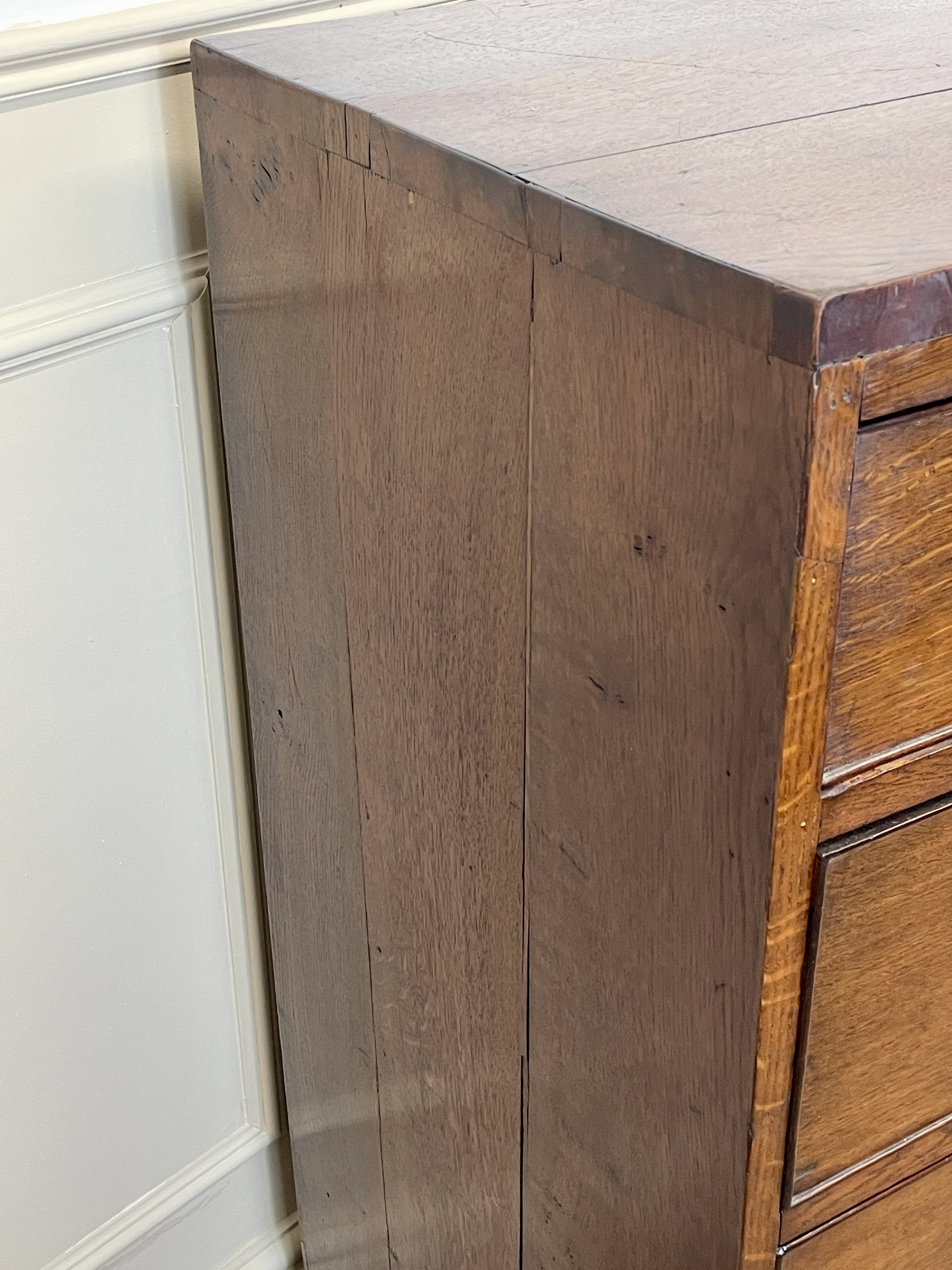 Wooden cabinet with a white wall background