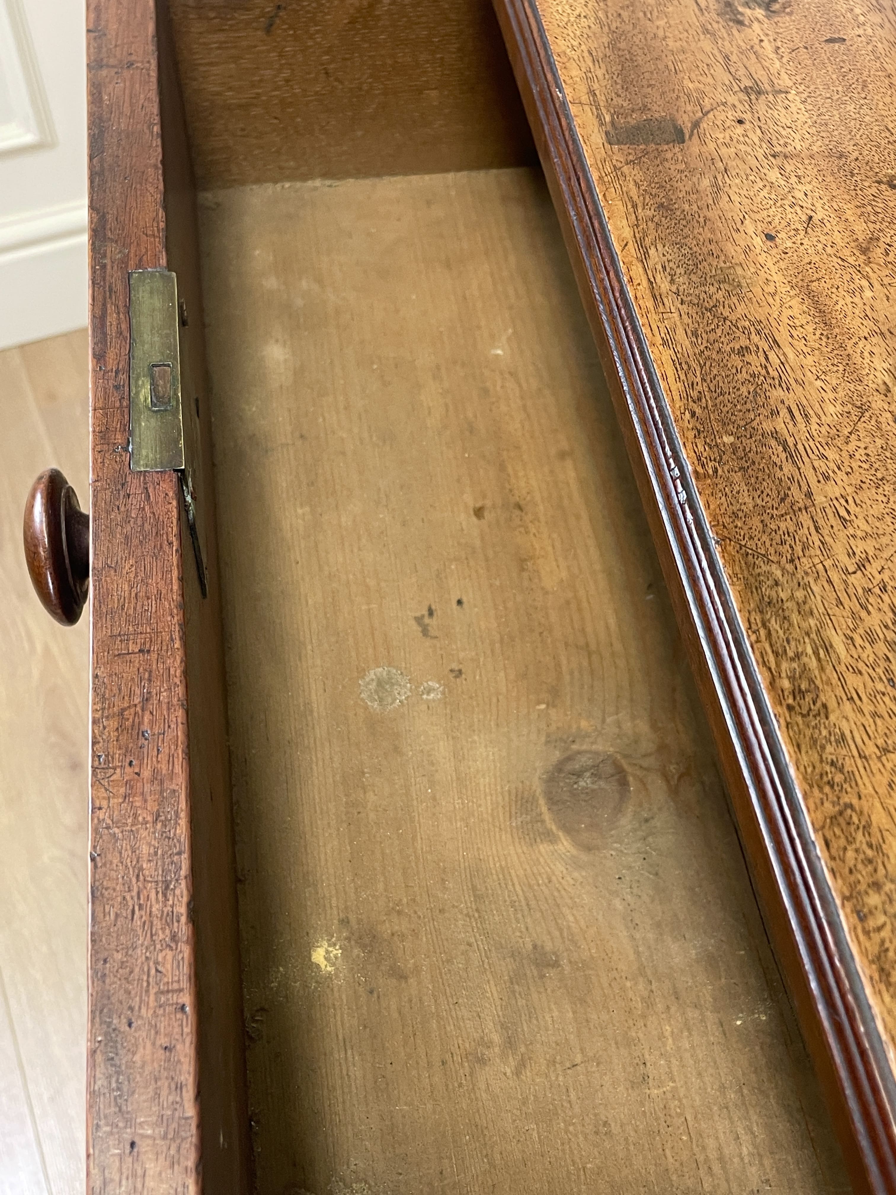 Close-up of a wooden drawer with visible wear and tear