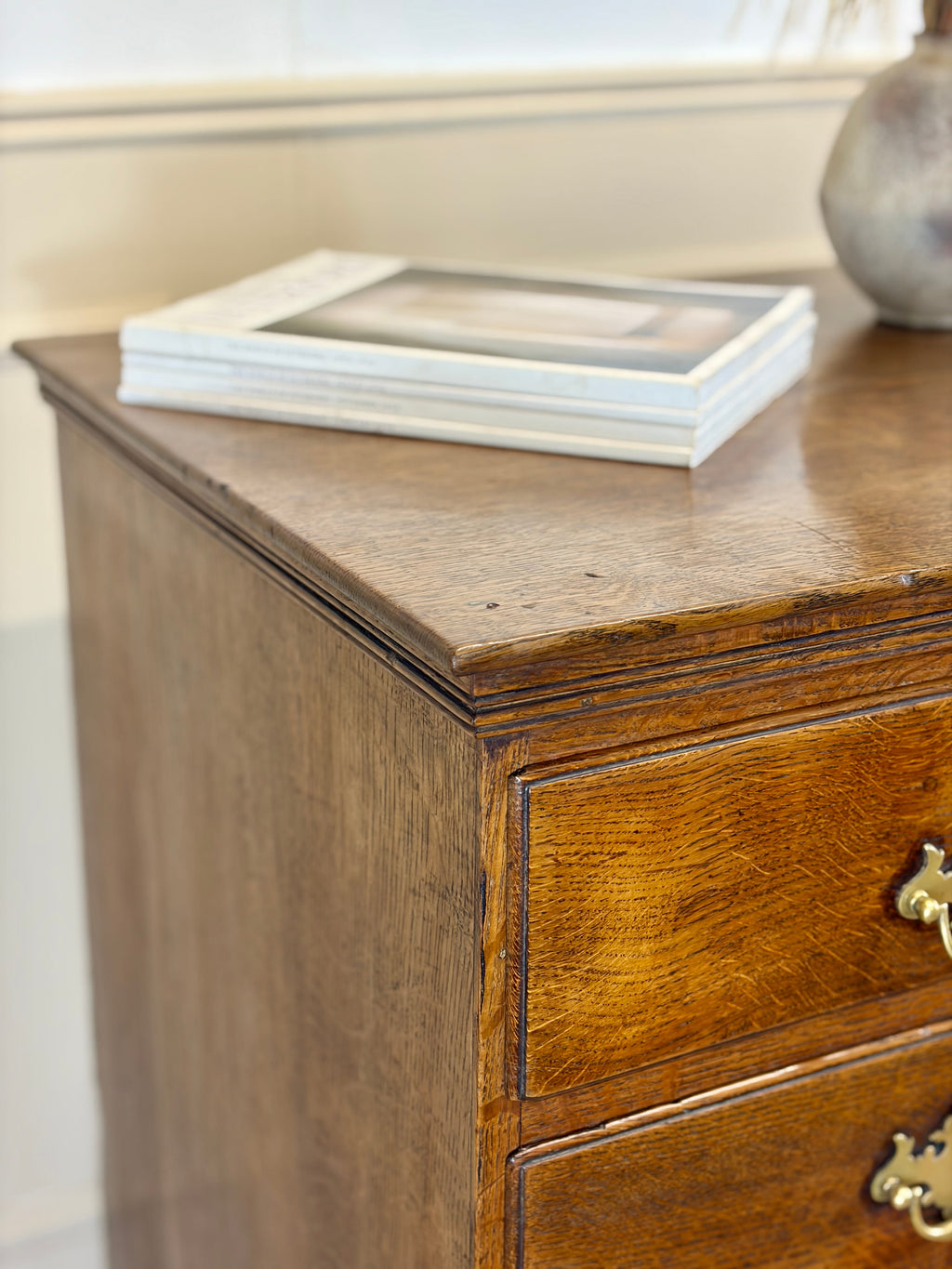 Antique light oak farmhouse chest of drawers with brass handles and patina