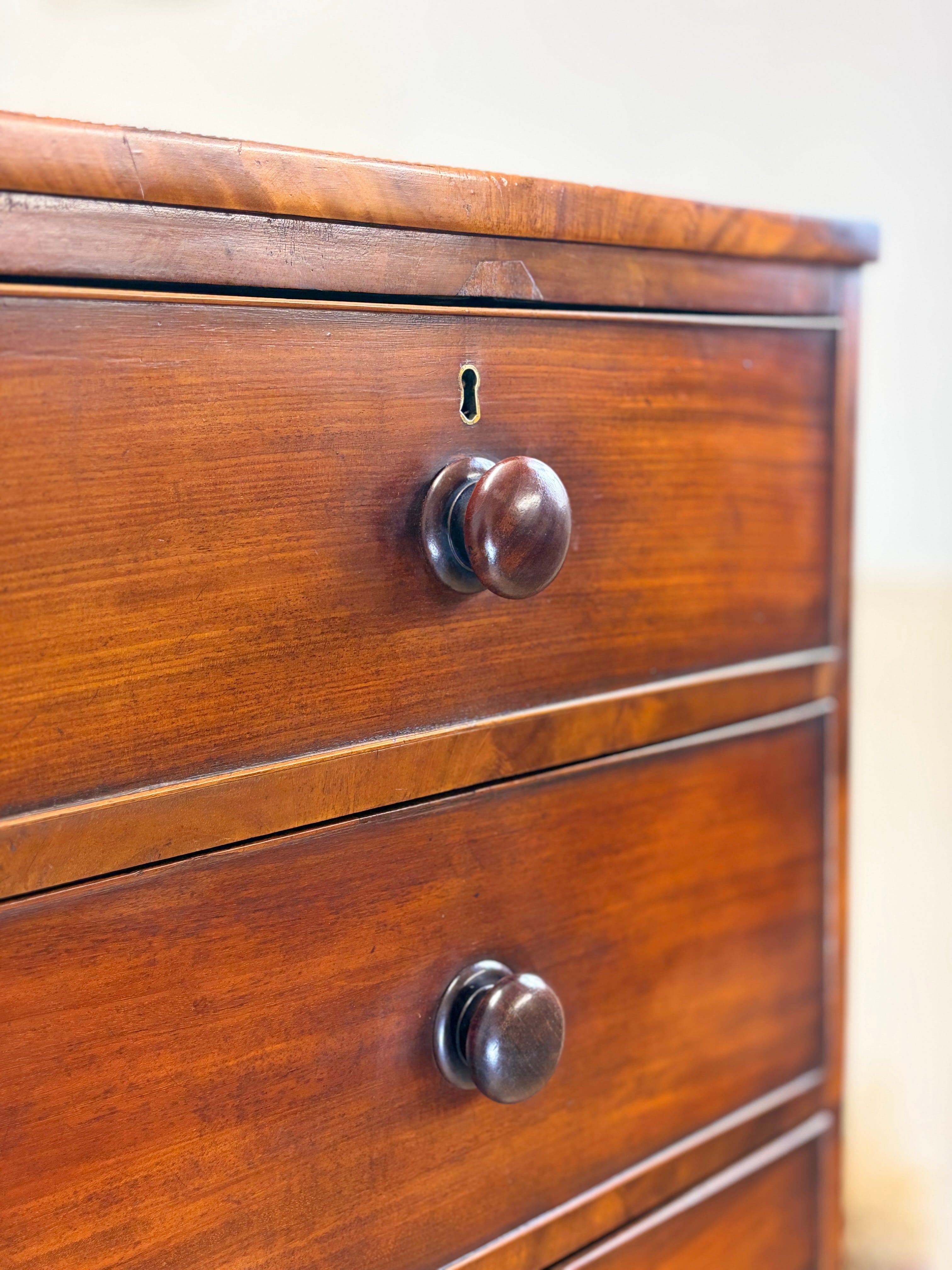 Close-up of a wooden dresser with two drawers and metal handles.