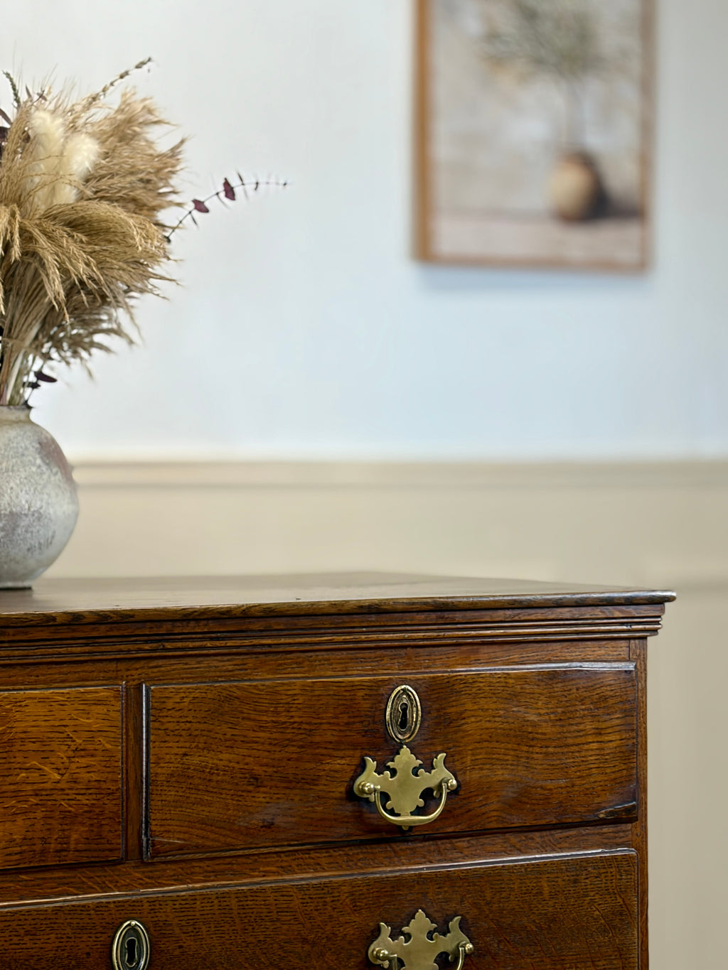 Antique light oak farmhouse chest of drawers with brass handles and patina
