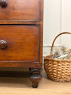 Wooden dresser with wicker basket on a wooden floor