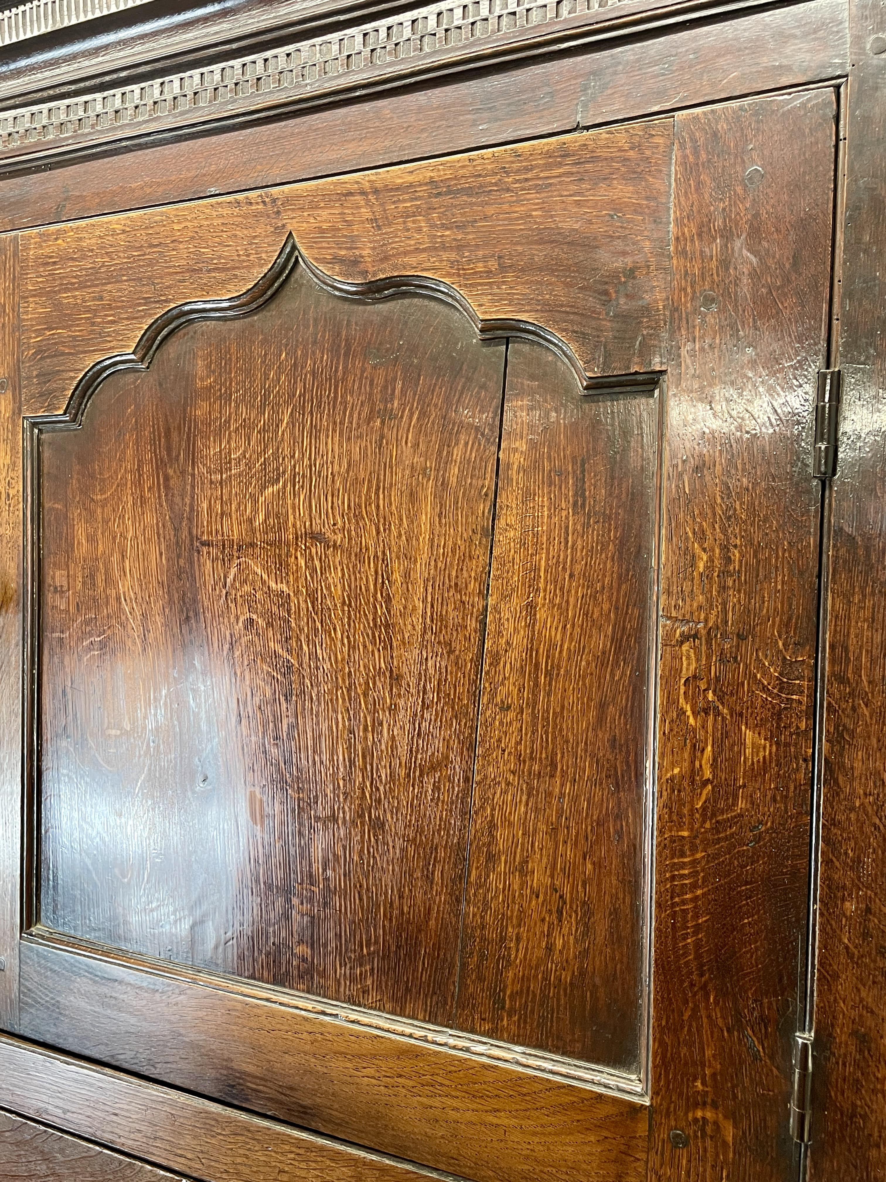 Close-up of a wooden cabinet door with intricate carvings