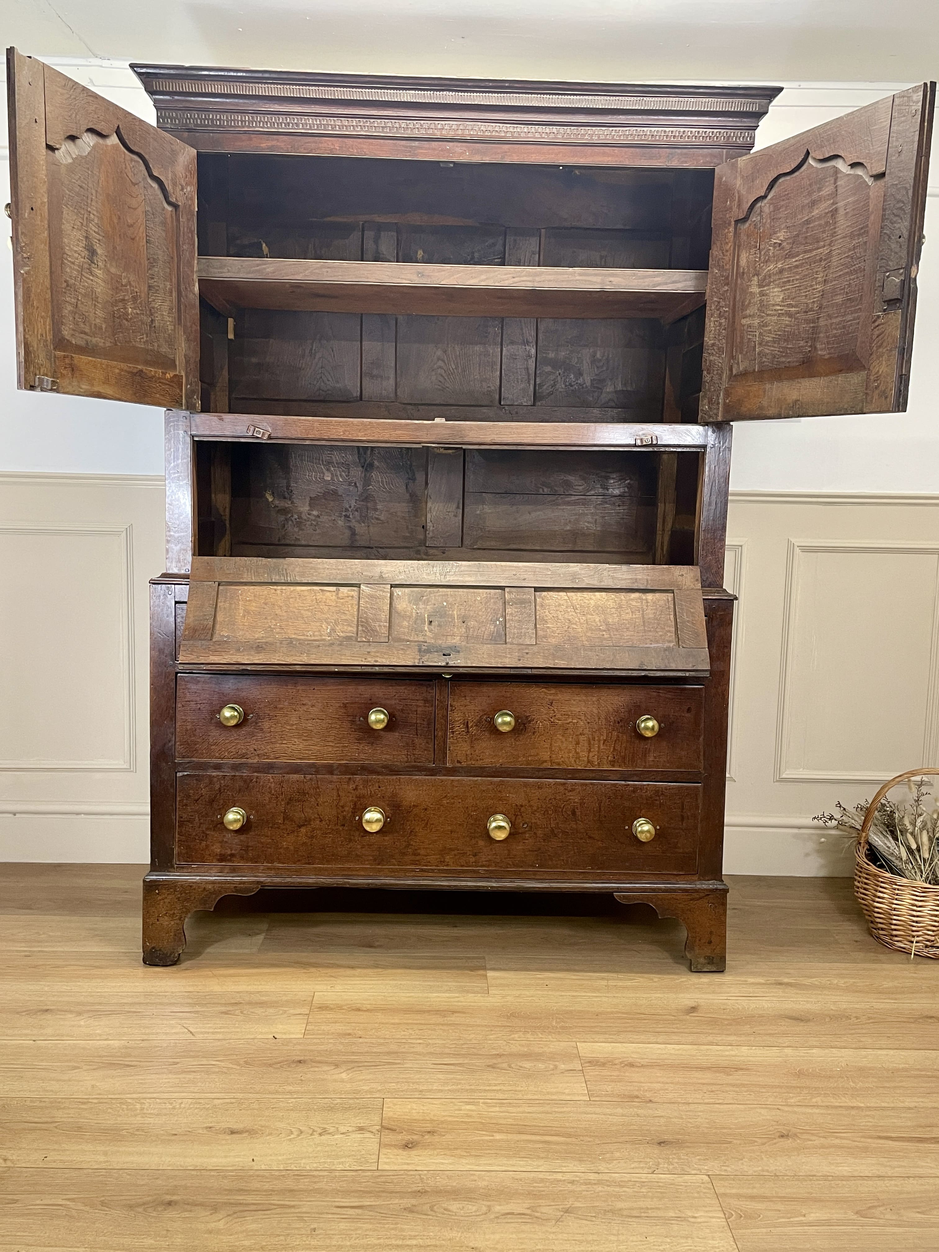Wooden cabinet with open doors on a wooden floor