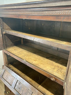 Wooden bookshelf with a dark finish and visible wear.