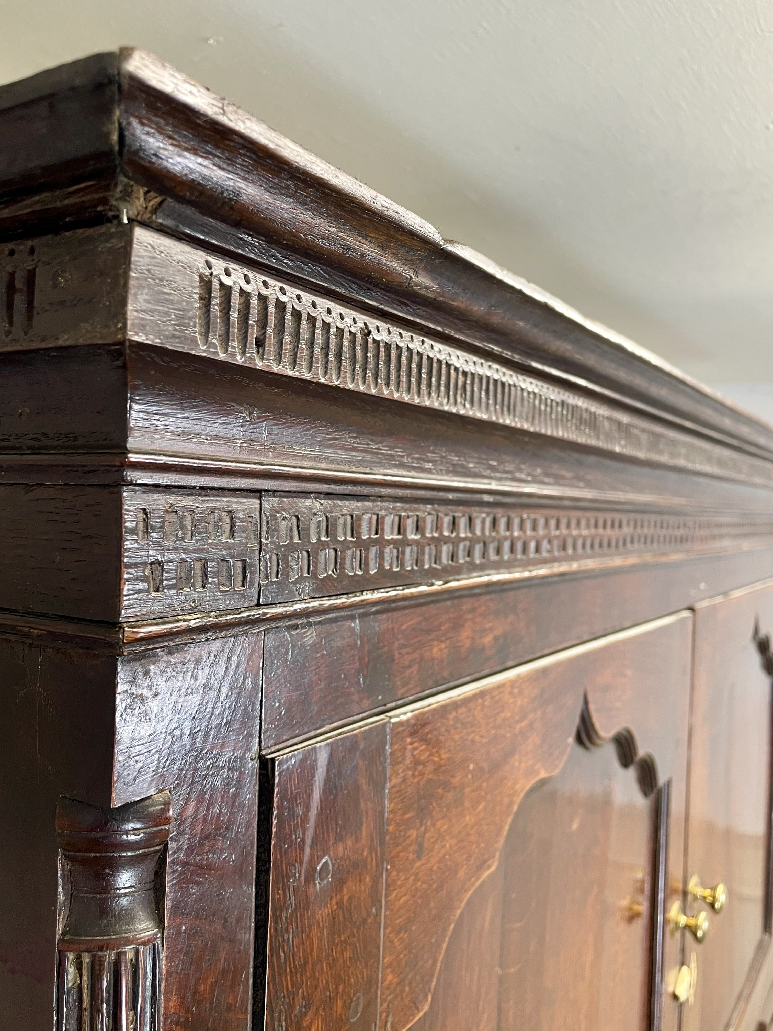 Close-up of an ornate wooden fireplace mantel with intricate carvings.