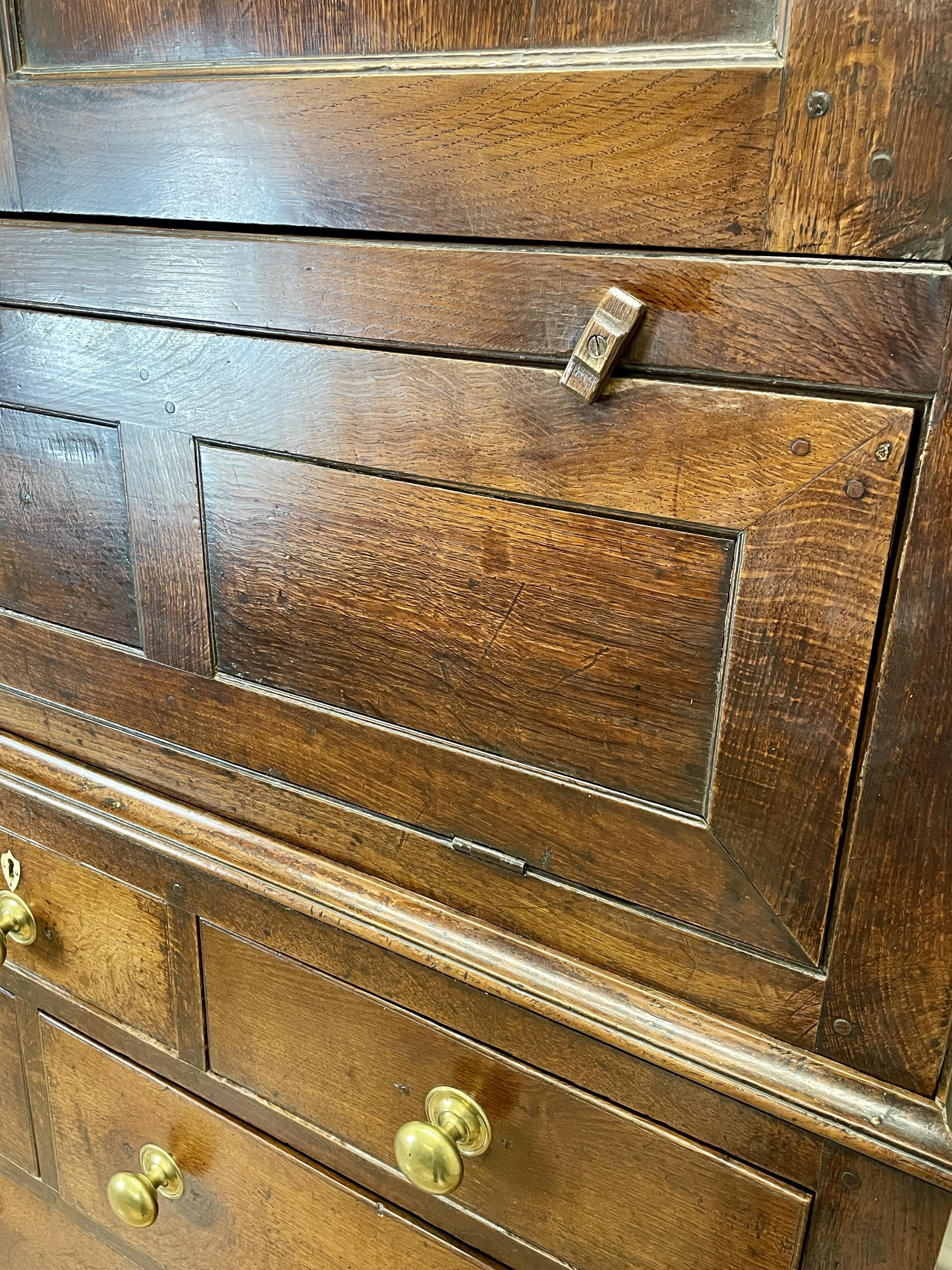 Close-up of a wooden cabinet with brass handles