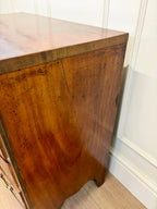 Wooden cabinet with a marble top in a room setting