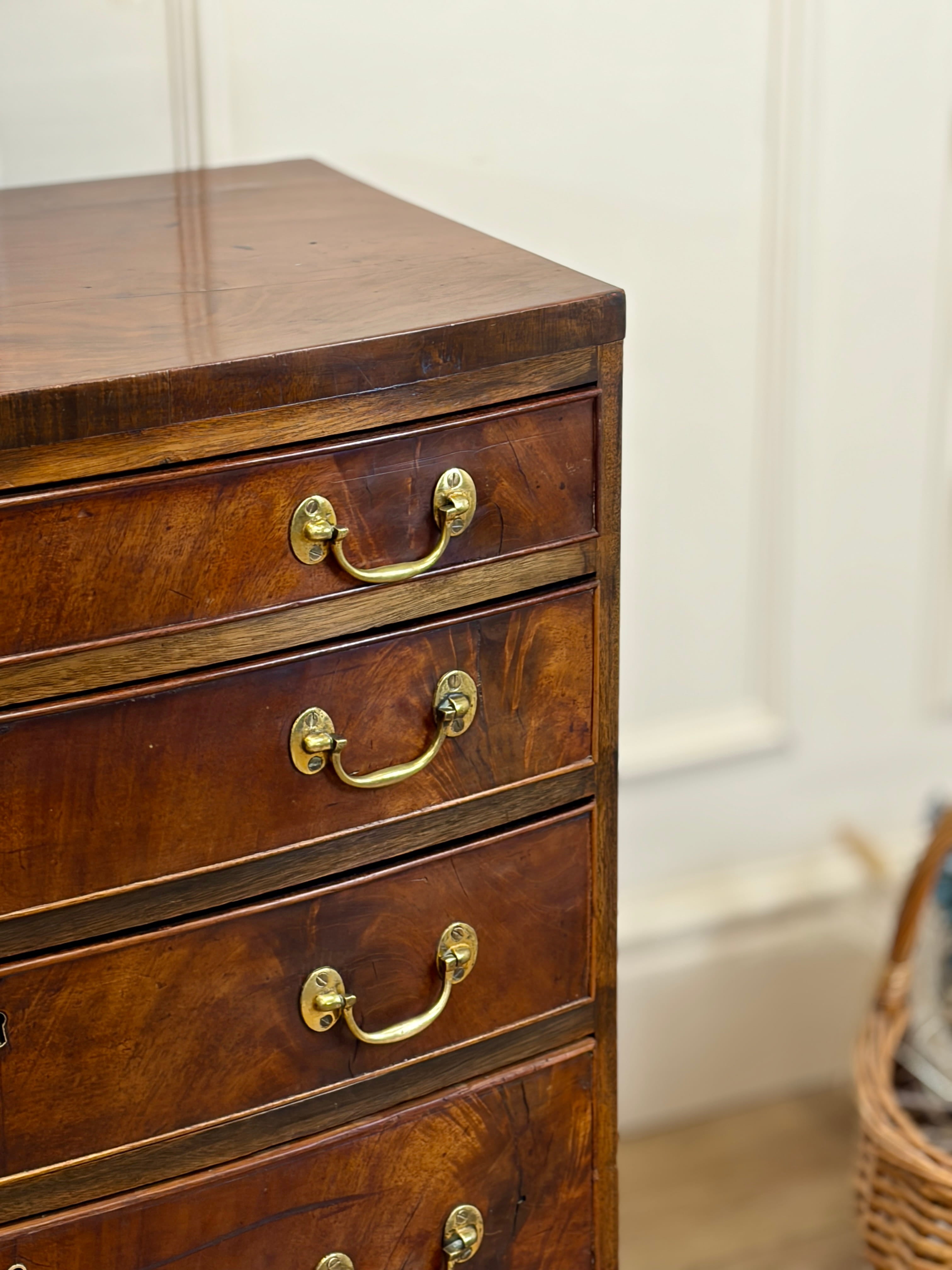 Wooden dresser with brass handles in a room setting