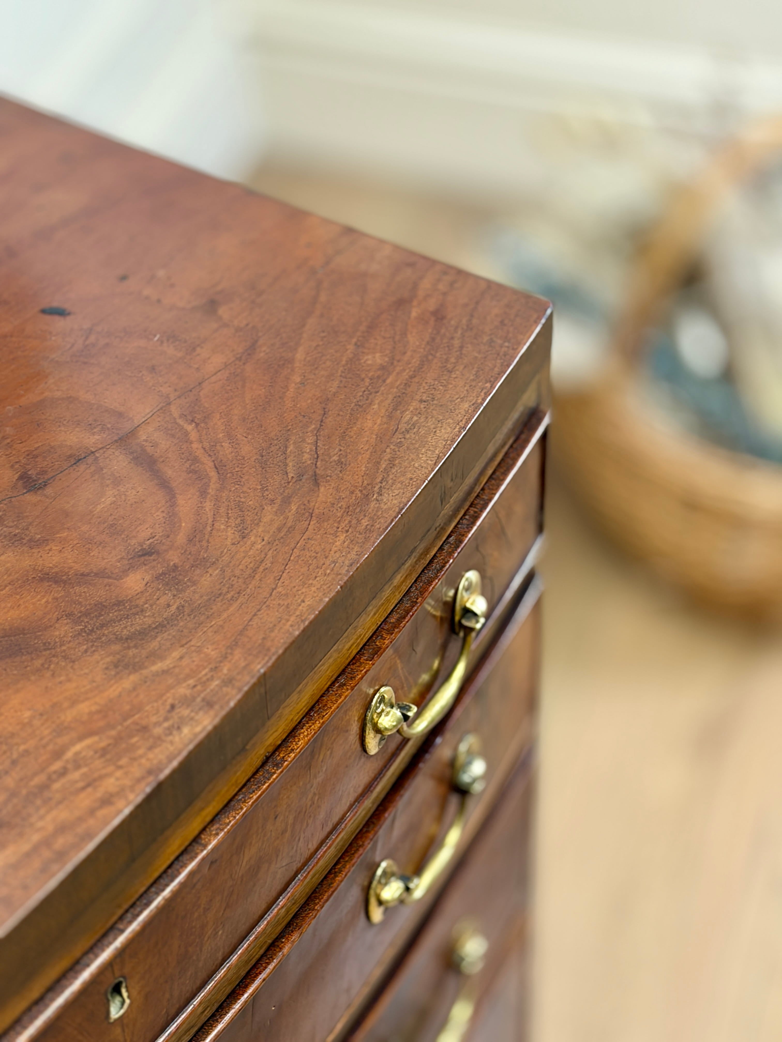 Wooden dresser with gold handles on a blurred background