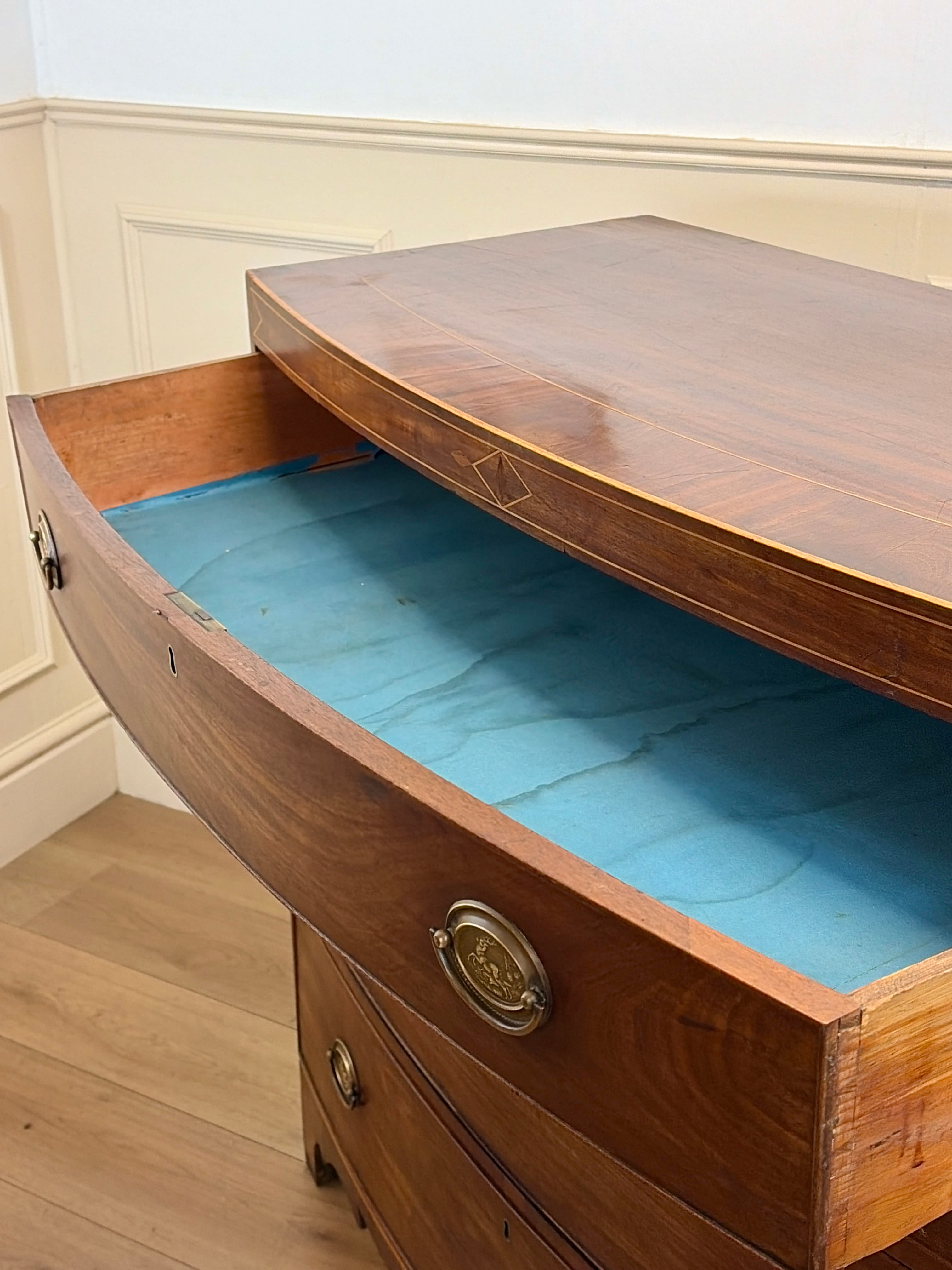 Wooden boat-shaped chest with a blue interior, open to reveal its contents.