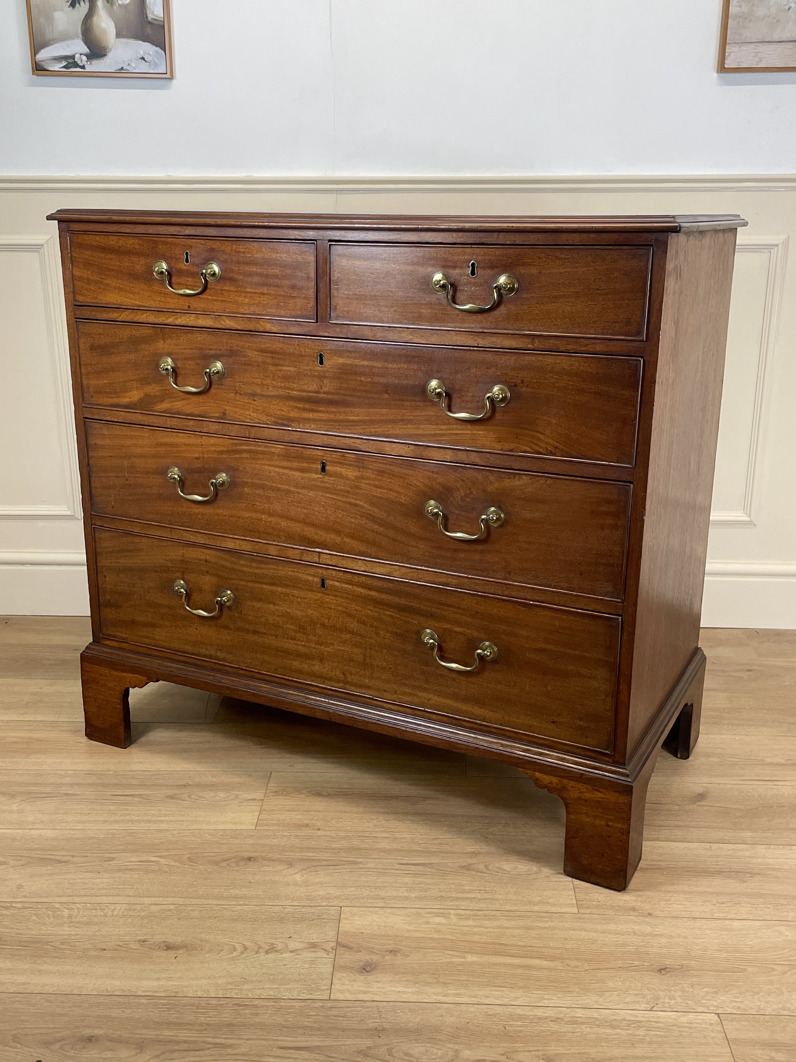Antique Early Georgian mahogany straight front chest of drawers with original brass handles and flame mahogany finish, professionally restored by Taylors Antiques & Interiors.