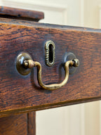 Close-up of a wooden drawer with brass handle and keyhole.