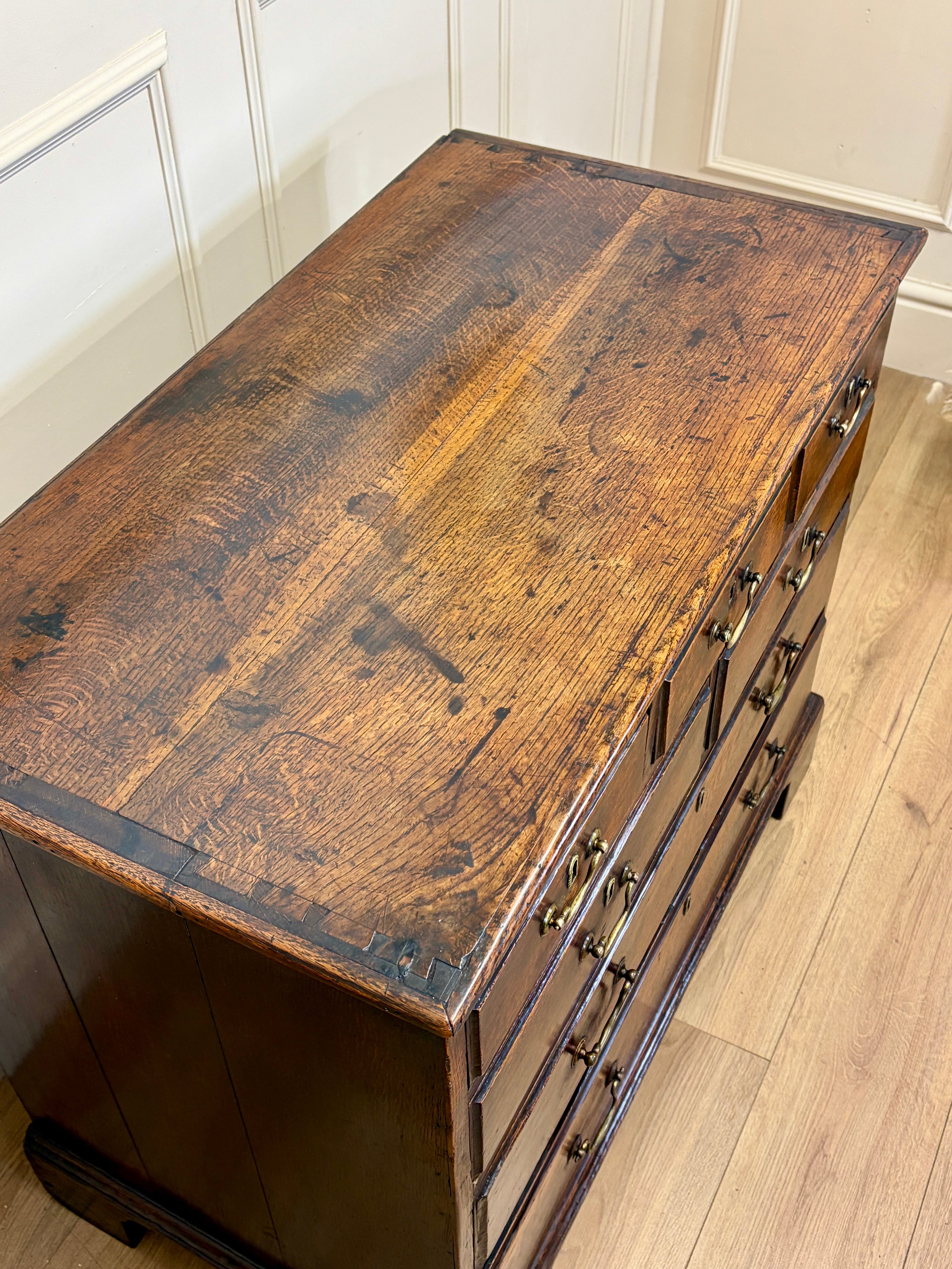 Wooden dresser with a weathered finish on a wooden floor.