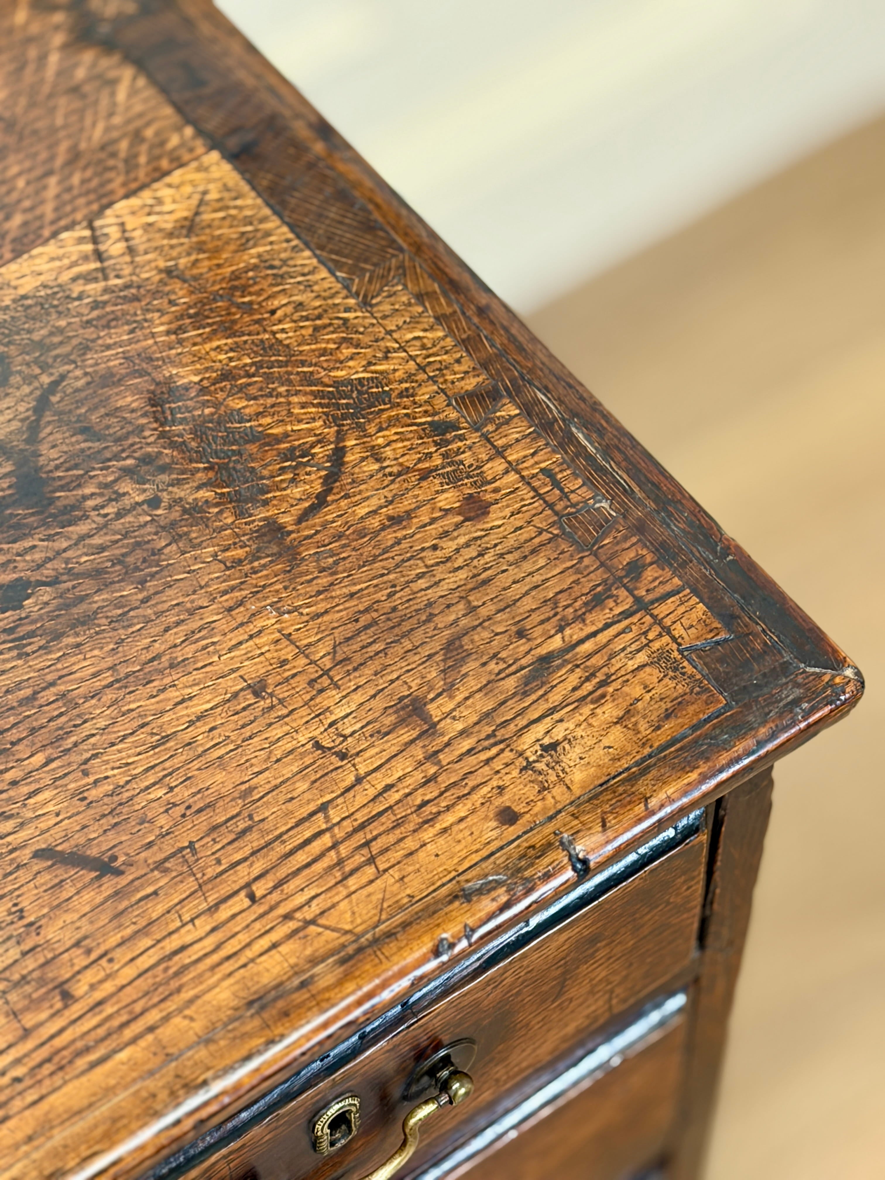 Close-up of an old wooden drawer with visible wear and tear.