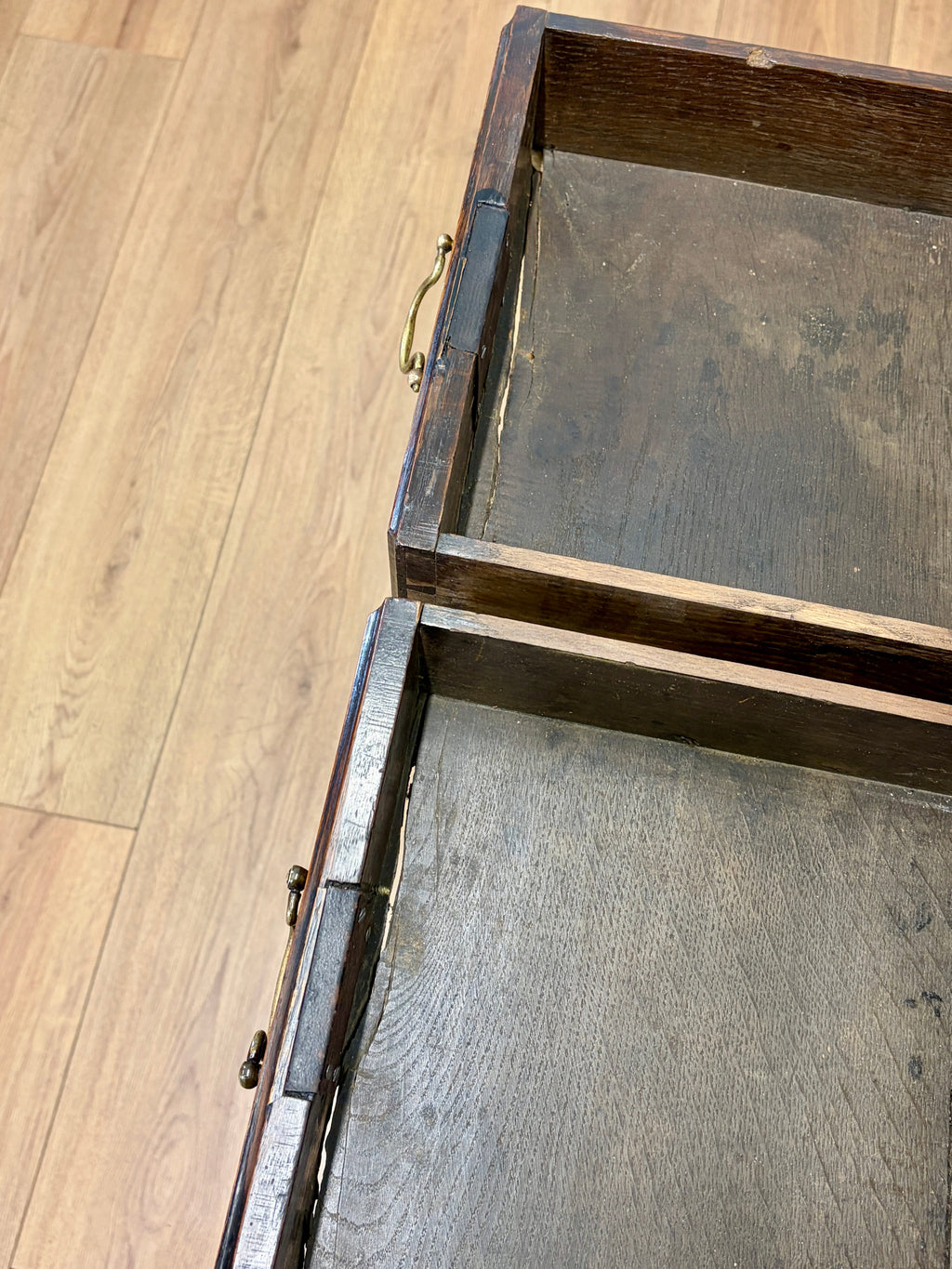 Wooden drawer with a metal handle on a wooden floor
