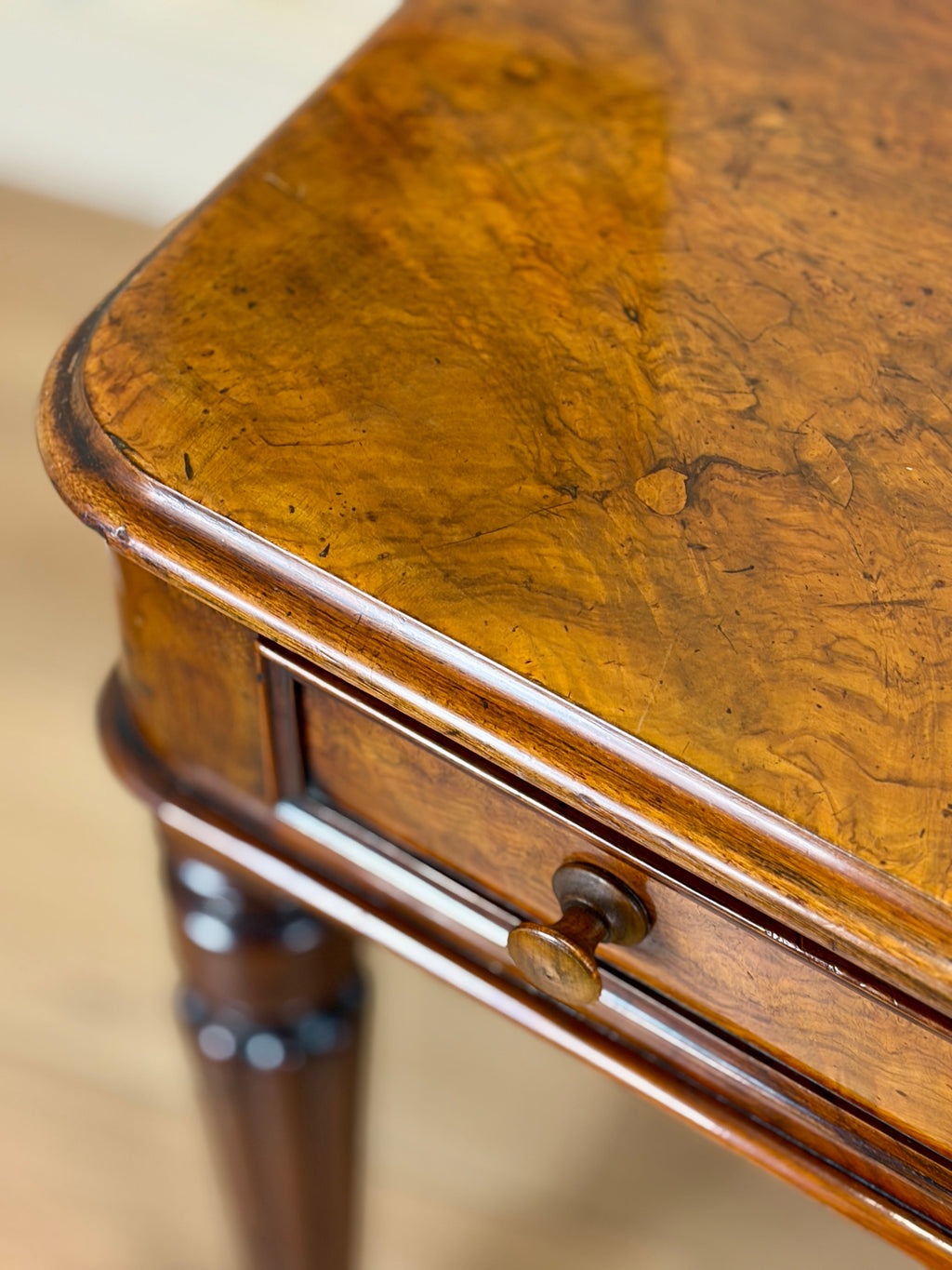 Close-up of a wooden table with a drawer
