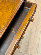Wooden desk with a glass top on a wooden floor
