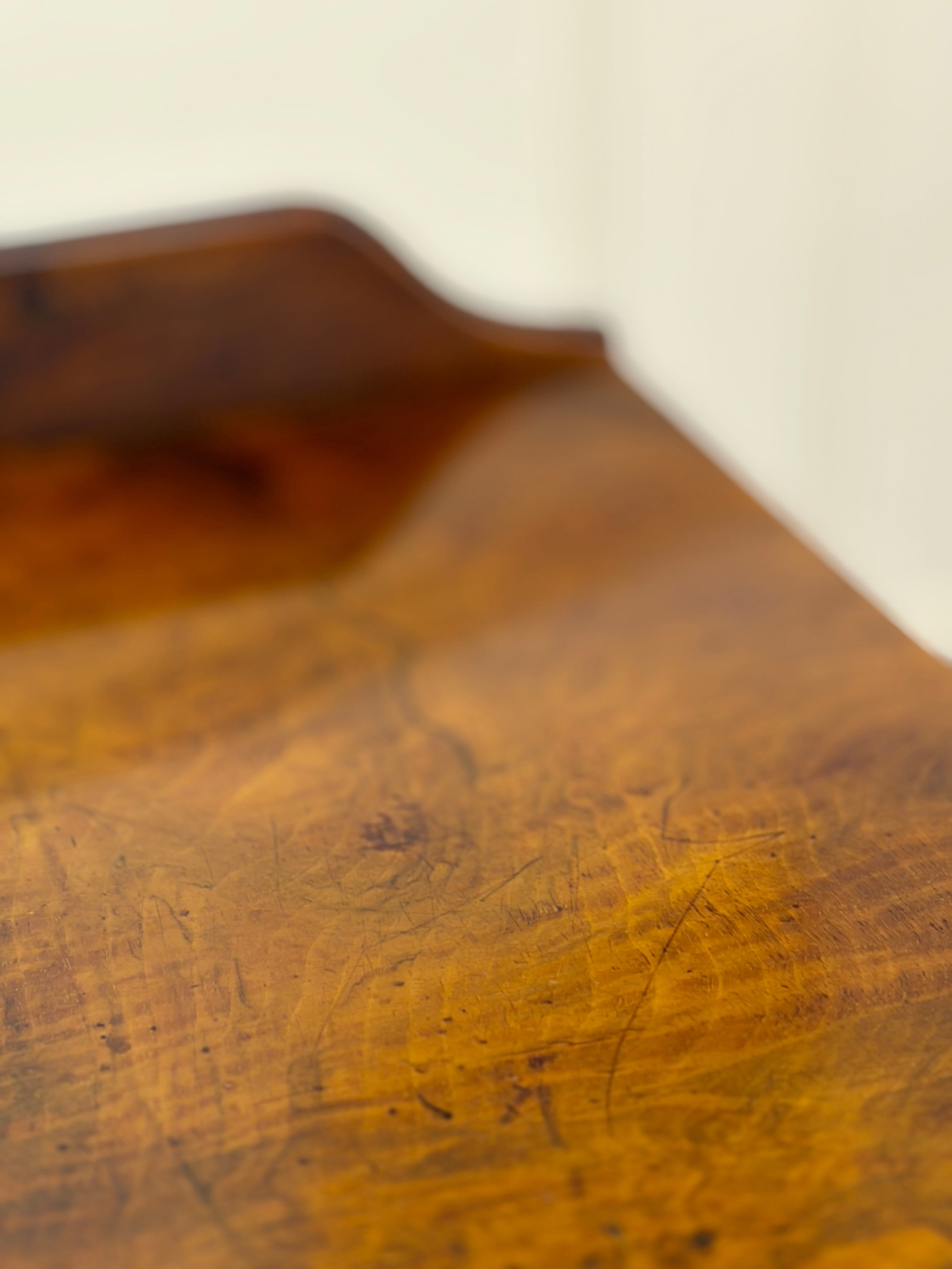 Close-up of a wooden surface with visible grain and texture.
