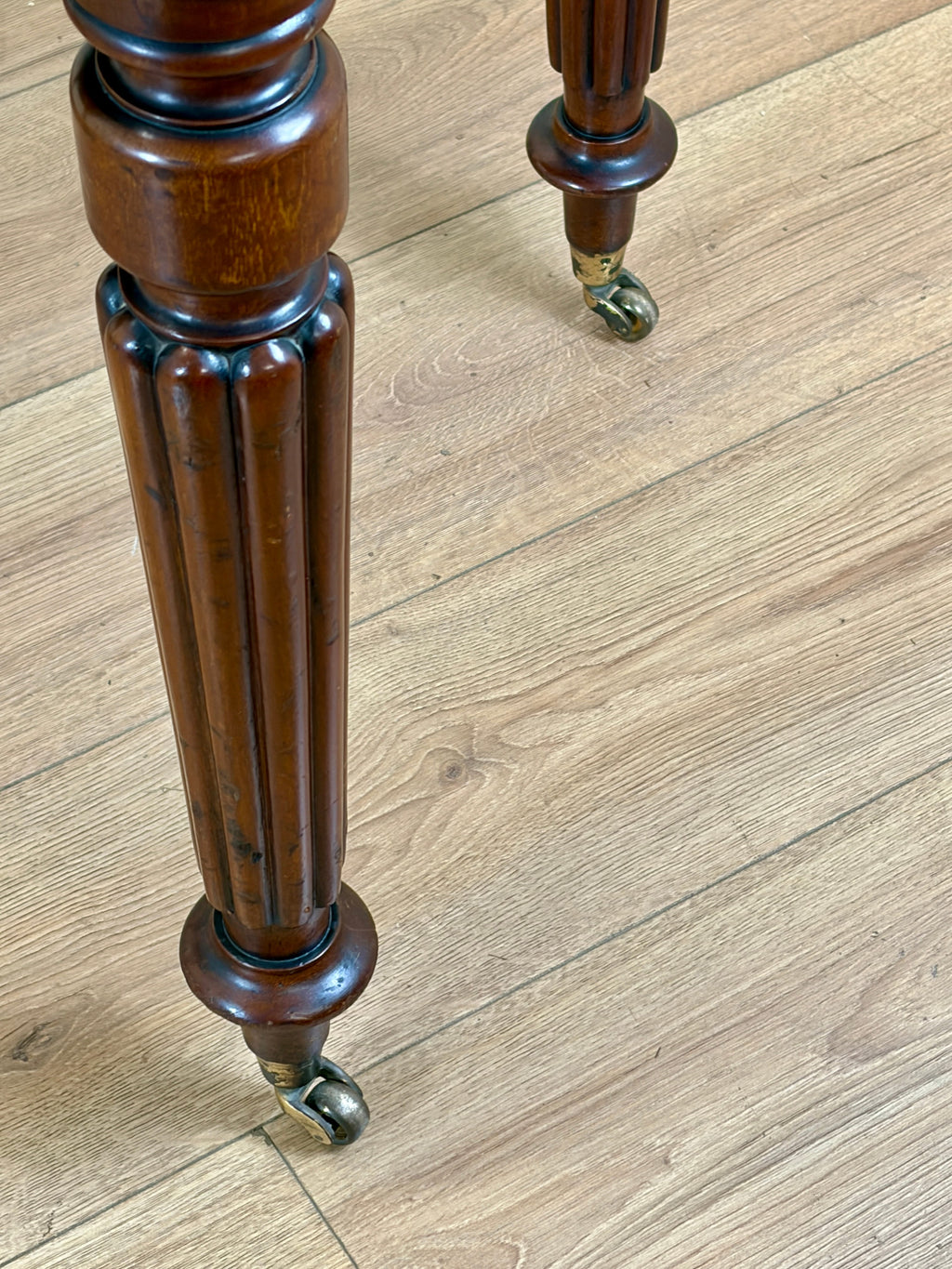 Wooden leg with decorative turnings on a wooden floor