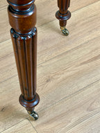 Wooden leg with decorative turnings on a wooden floor