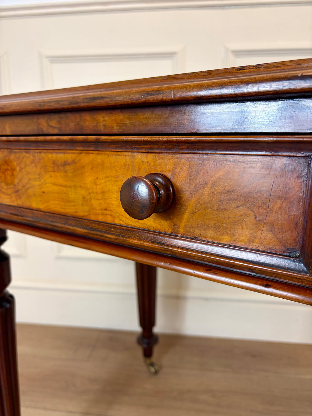 Wooden drawer with a knob on a wooden floor.