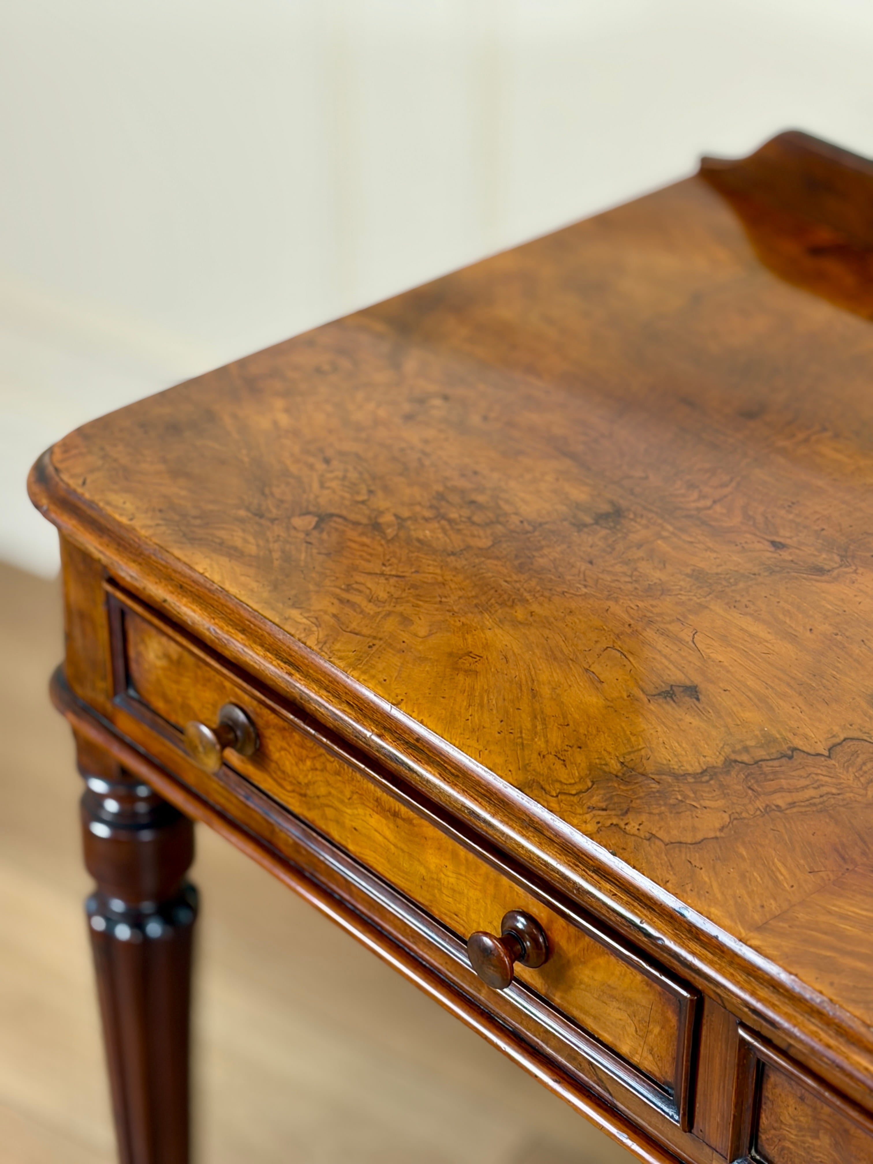 Wooden side table with a single drawer on a neutral background