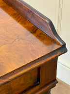 Close-up of a wooden desk with a smooth surface and curved edge.