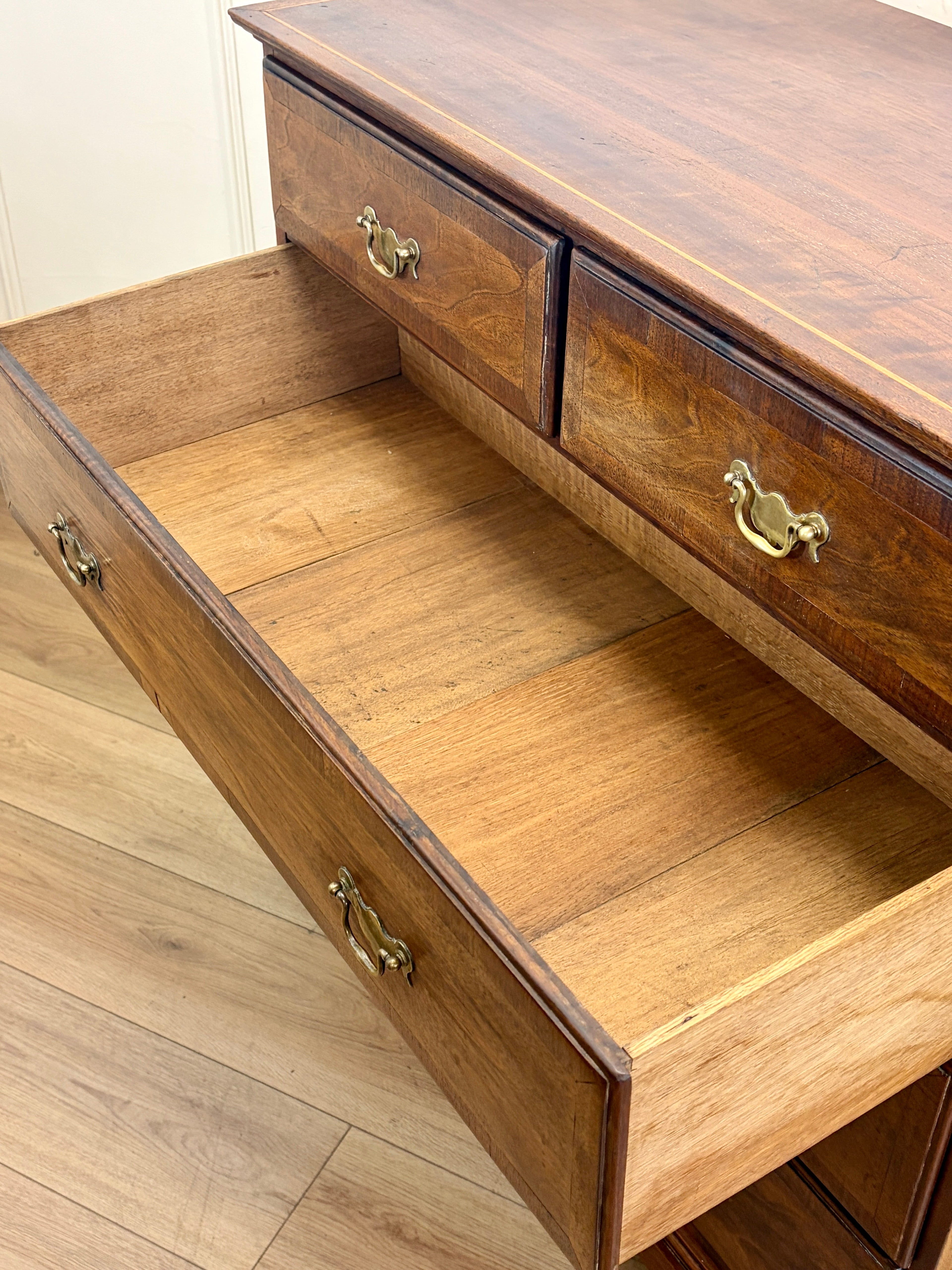 Wooden dresser with open drawers on a wooden floor