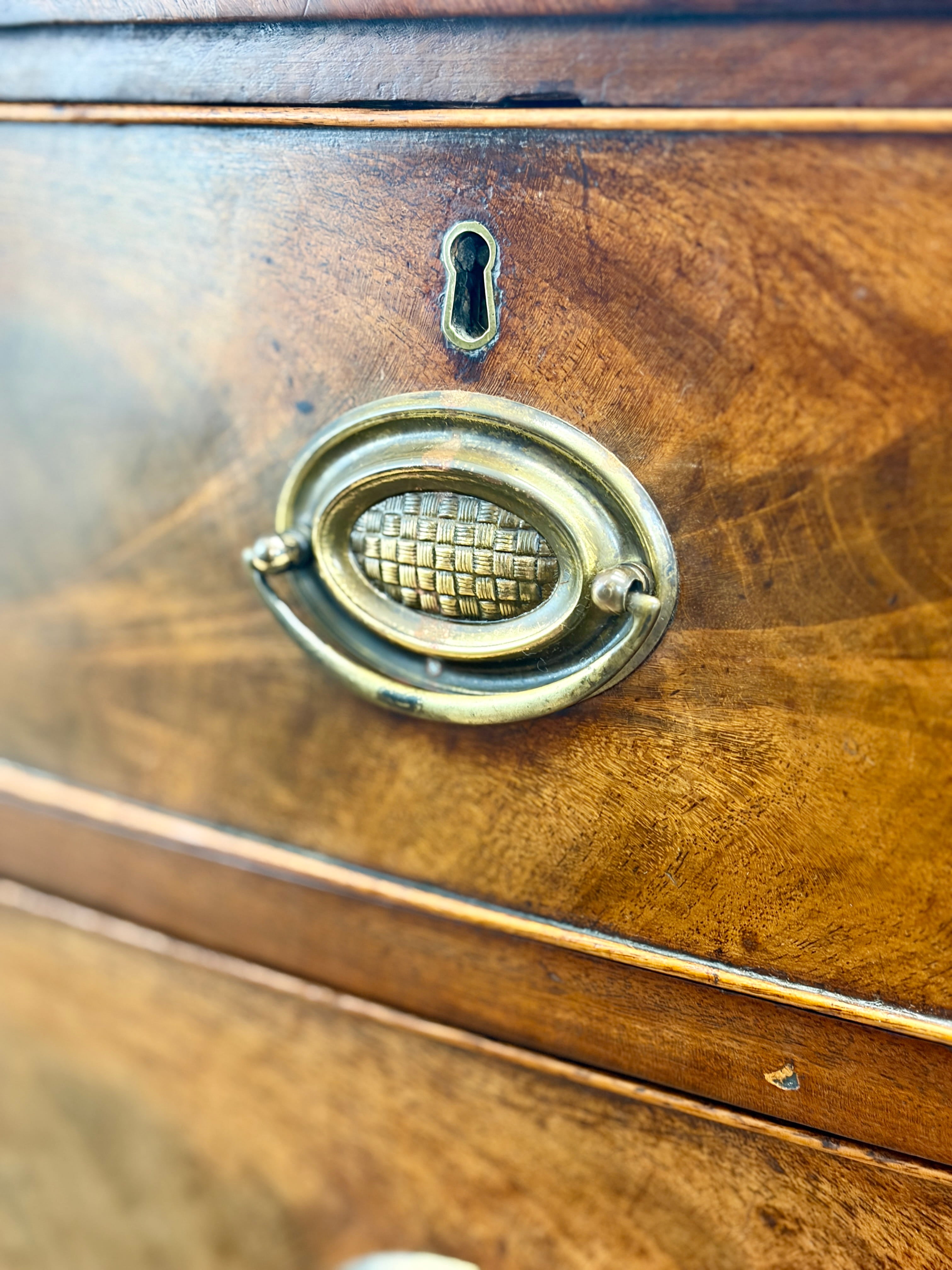 Close-up of a wooden drawer with a brass handle