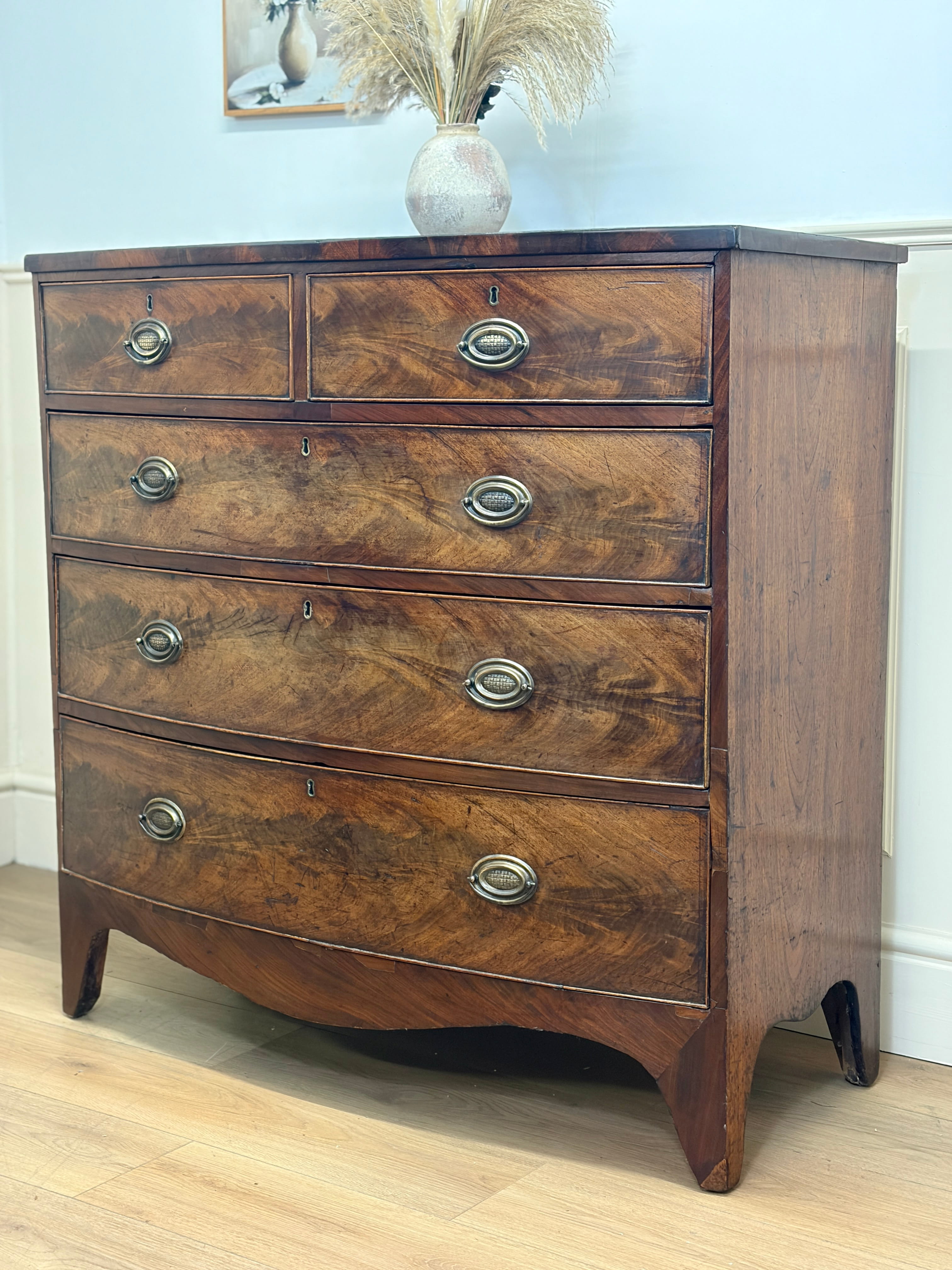 Wooden dresser with four drawers in a room setting