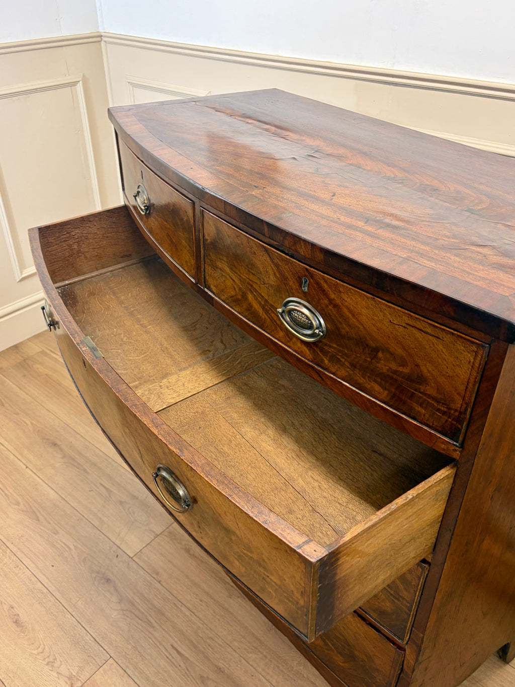 Wooden sideboard with two drawers on a wooden floor.