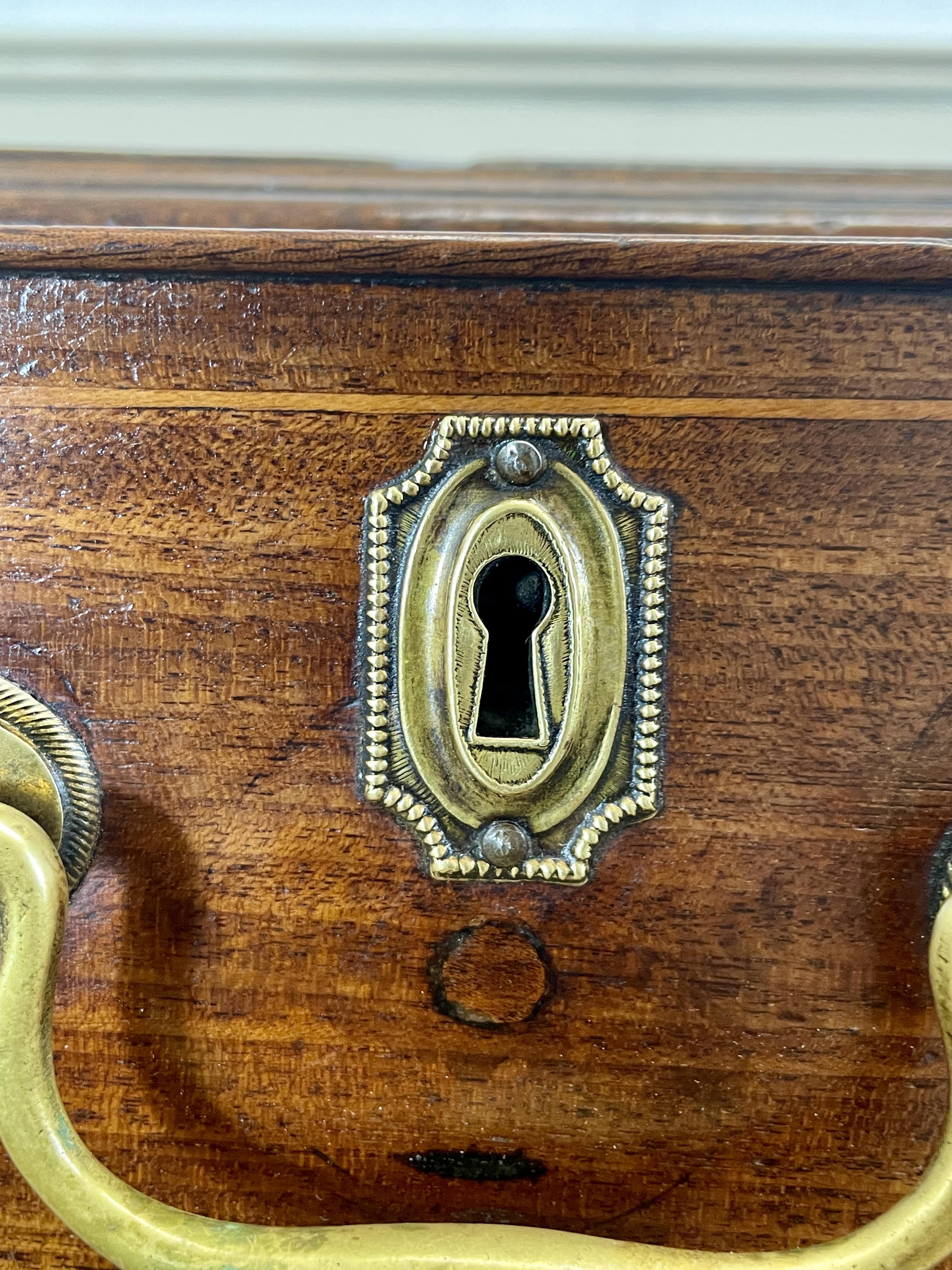 Wooden box with a brass keyhole and handles