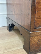 Close-up of a wooden cabinet with a white wall in the background