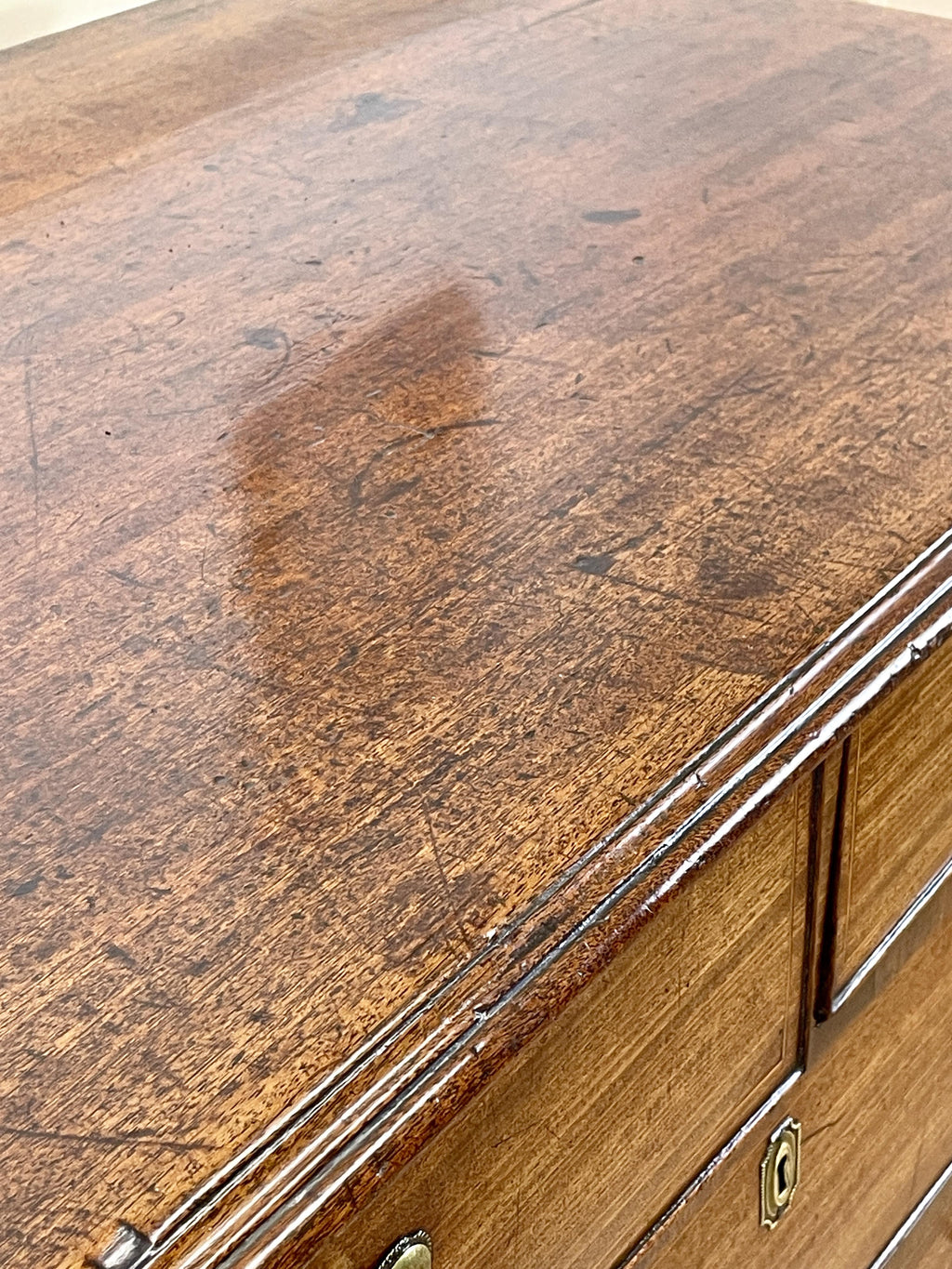 Close-up of a wooden surface with a large brown stain