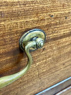 Brass handle on a wooden surface