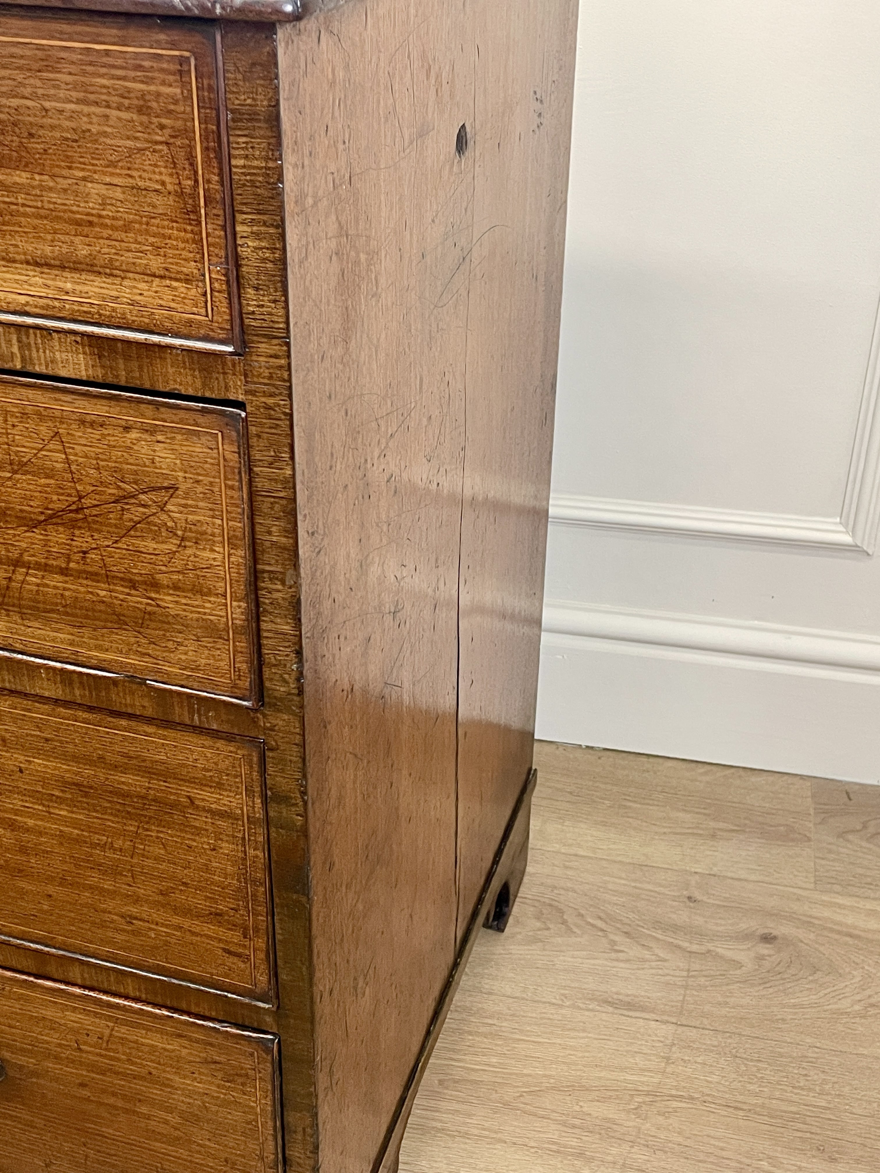 Wooden cabinet with a white wall and floor in the background