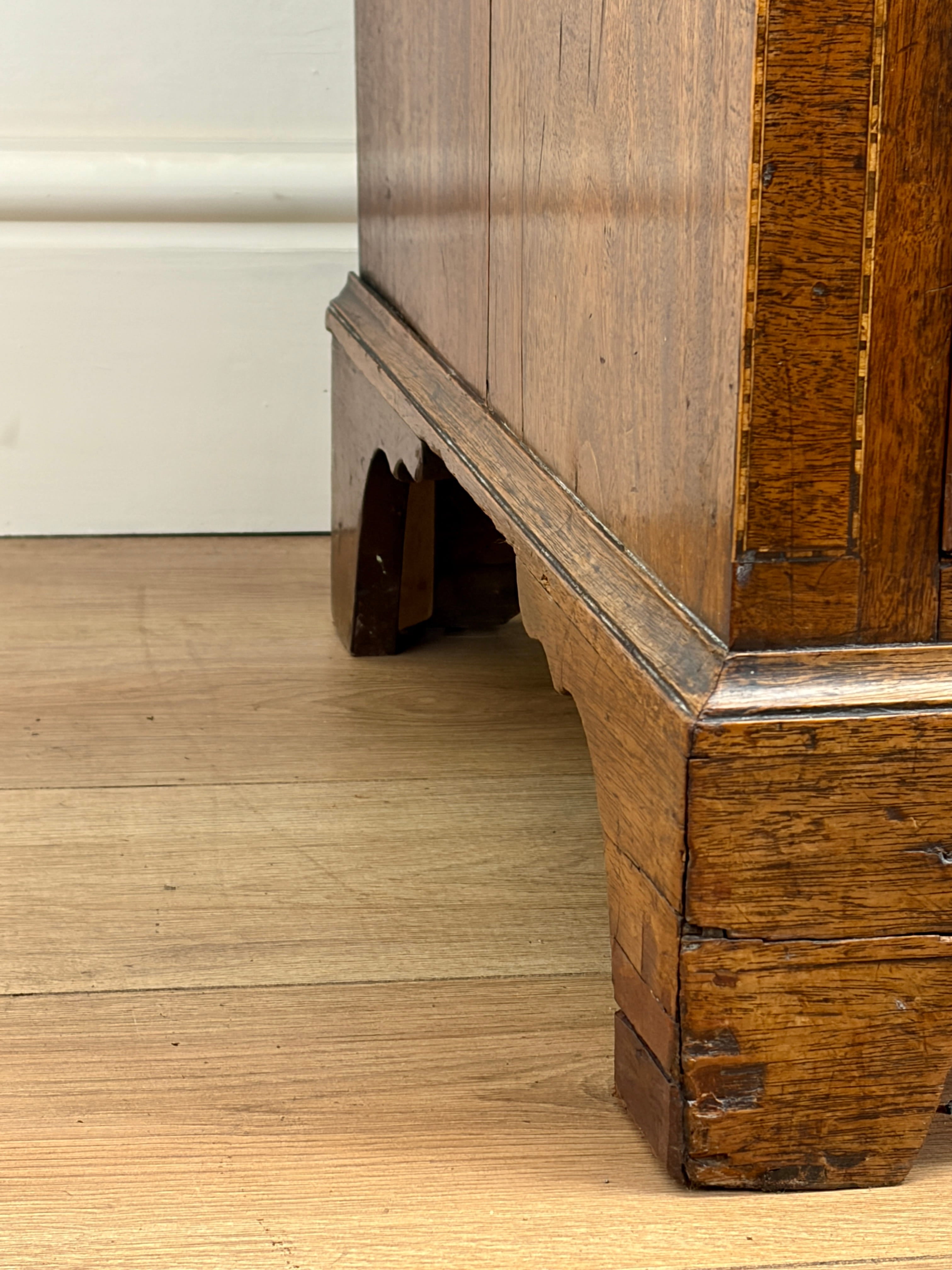 Close-up of a wooden cabinet corner on a wooden floor.