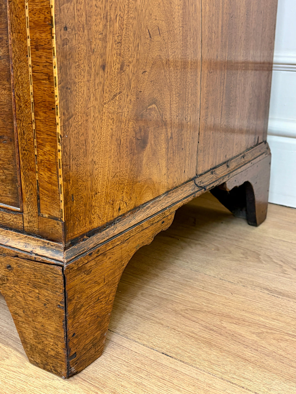 Wooden cabinet with a white wall background