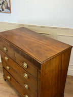 Wooden dresser with gold handles in a room setting