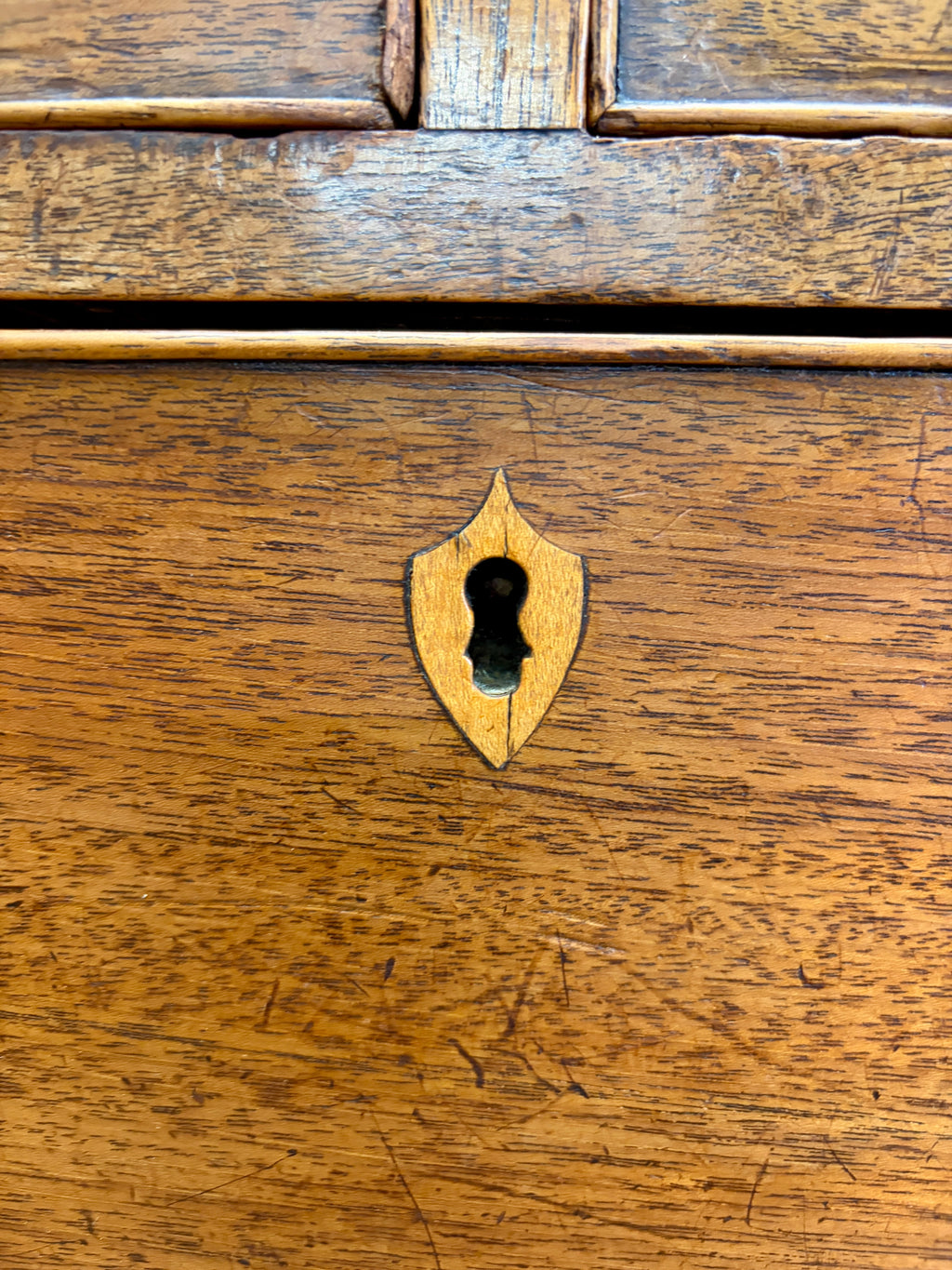 Close-up of a wooden drawer with a keyhole