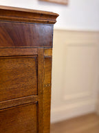 Close-up of a wooden cabinet corner with a blurred background